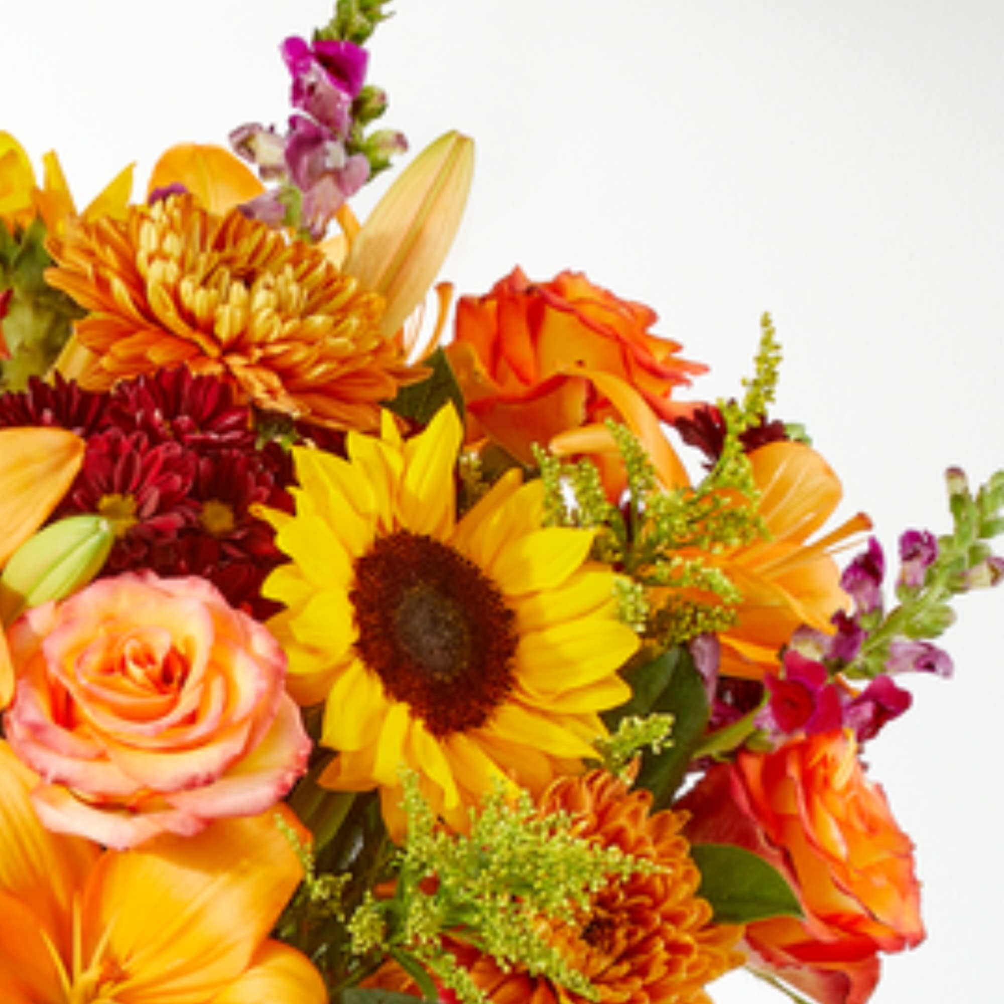 Bright mixed bouquet with sunflowers, roses, lilies, and orange blooms