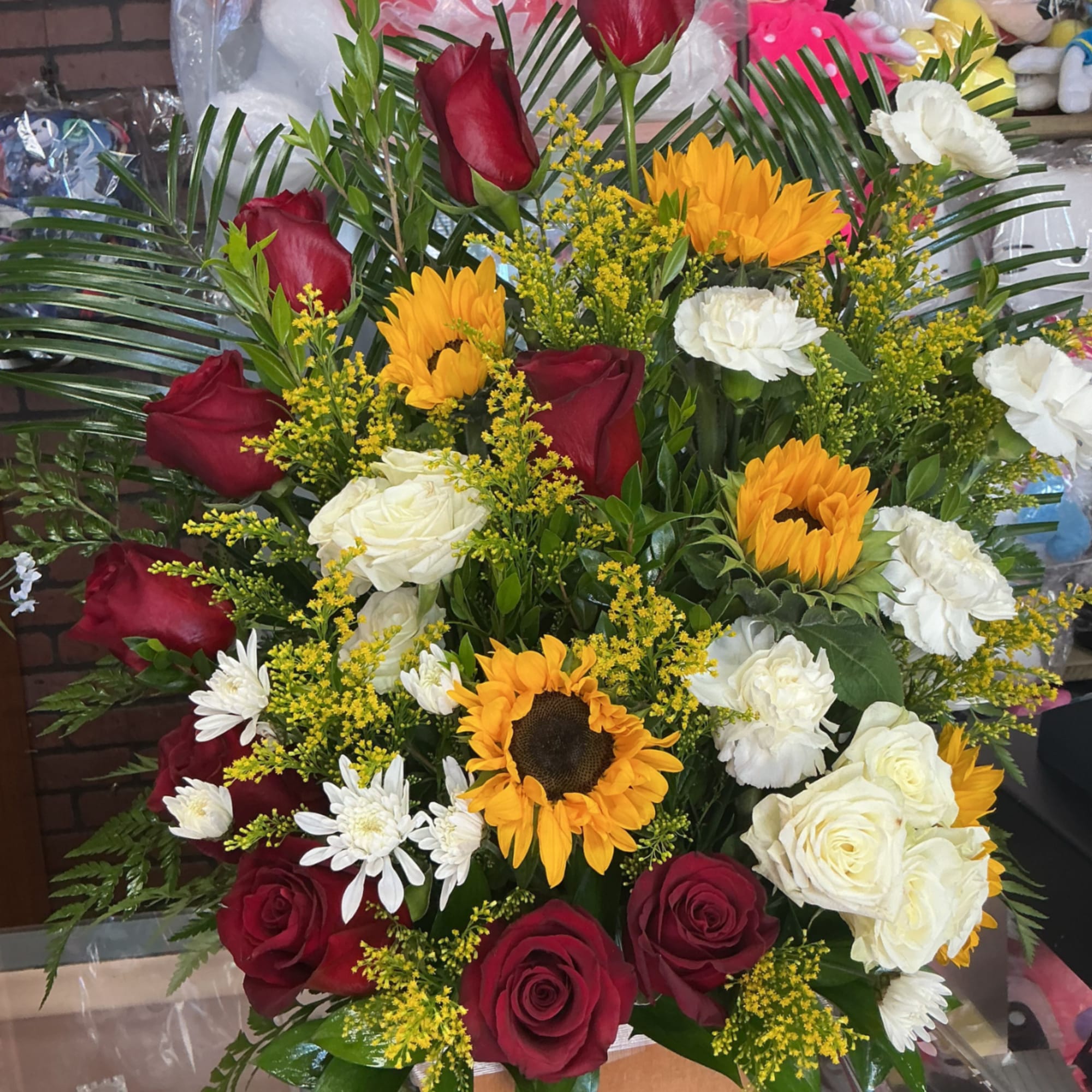 This big arrengment is made of red roses and some beautiful sunflowers, photo 2 of 2