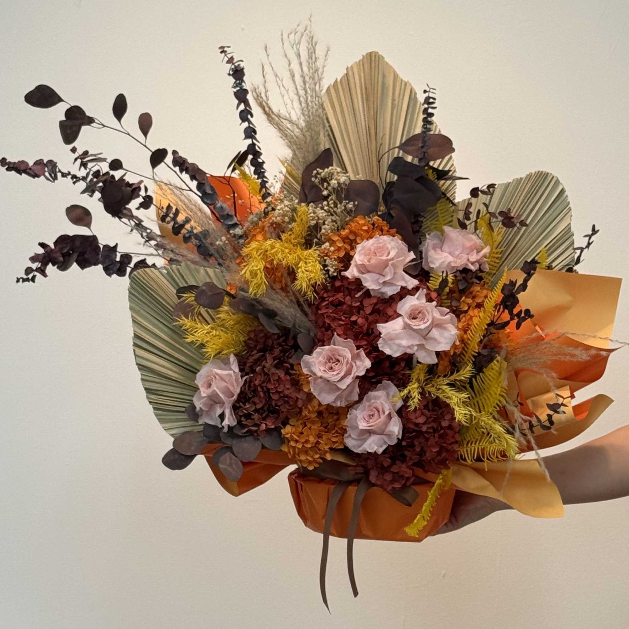 This is an autumn-themed or Bohemian-style basket of dried flowers.
Tone: The bouquet