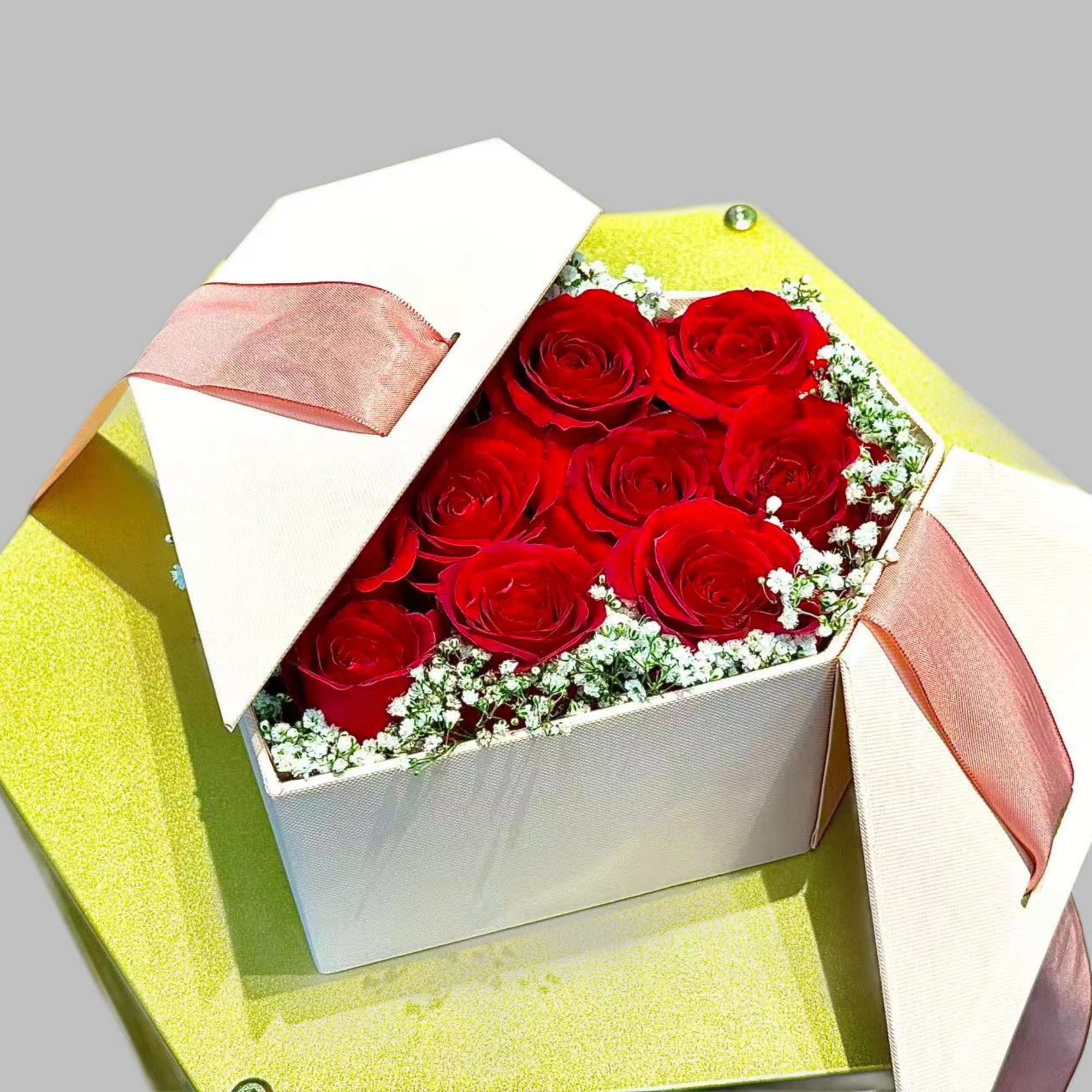 Box of red roses with baby's breath and ribbon