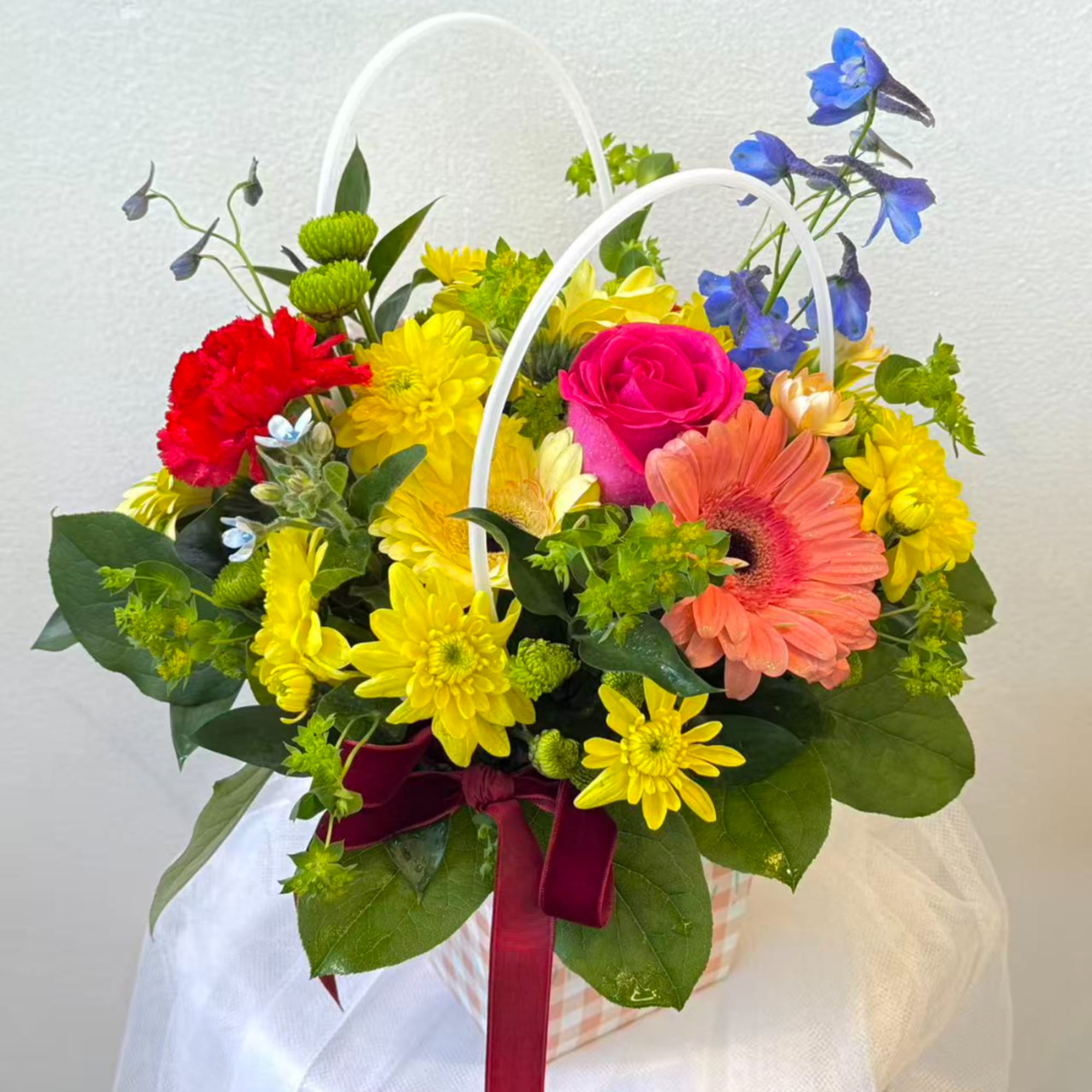 Colorful mixed flower basket with gerbera daisies and chrysanthemums