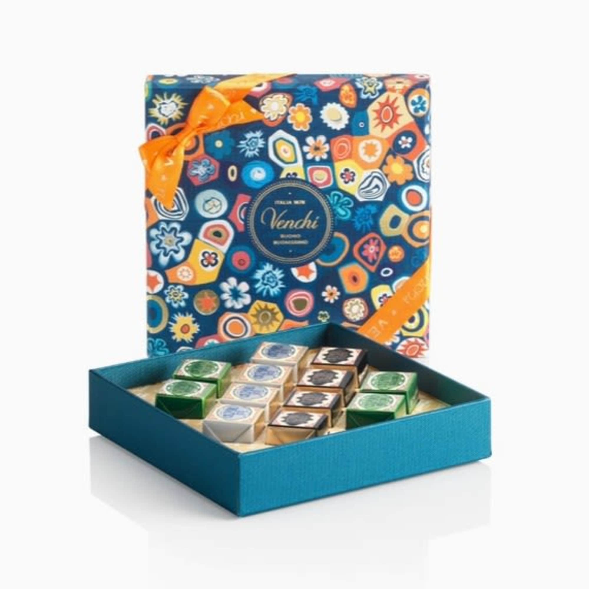 Box of assorted chocolates with a patterned lid and orange ribbon