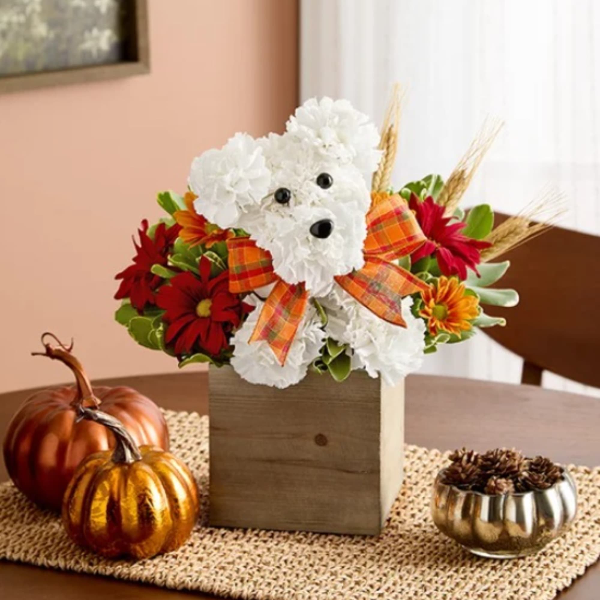 White floral dog arrangement in a wooden box with a plaid bow