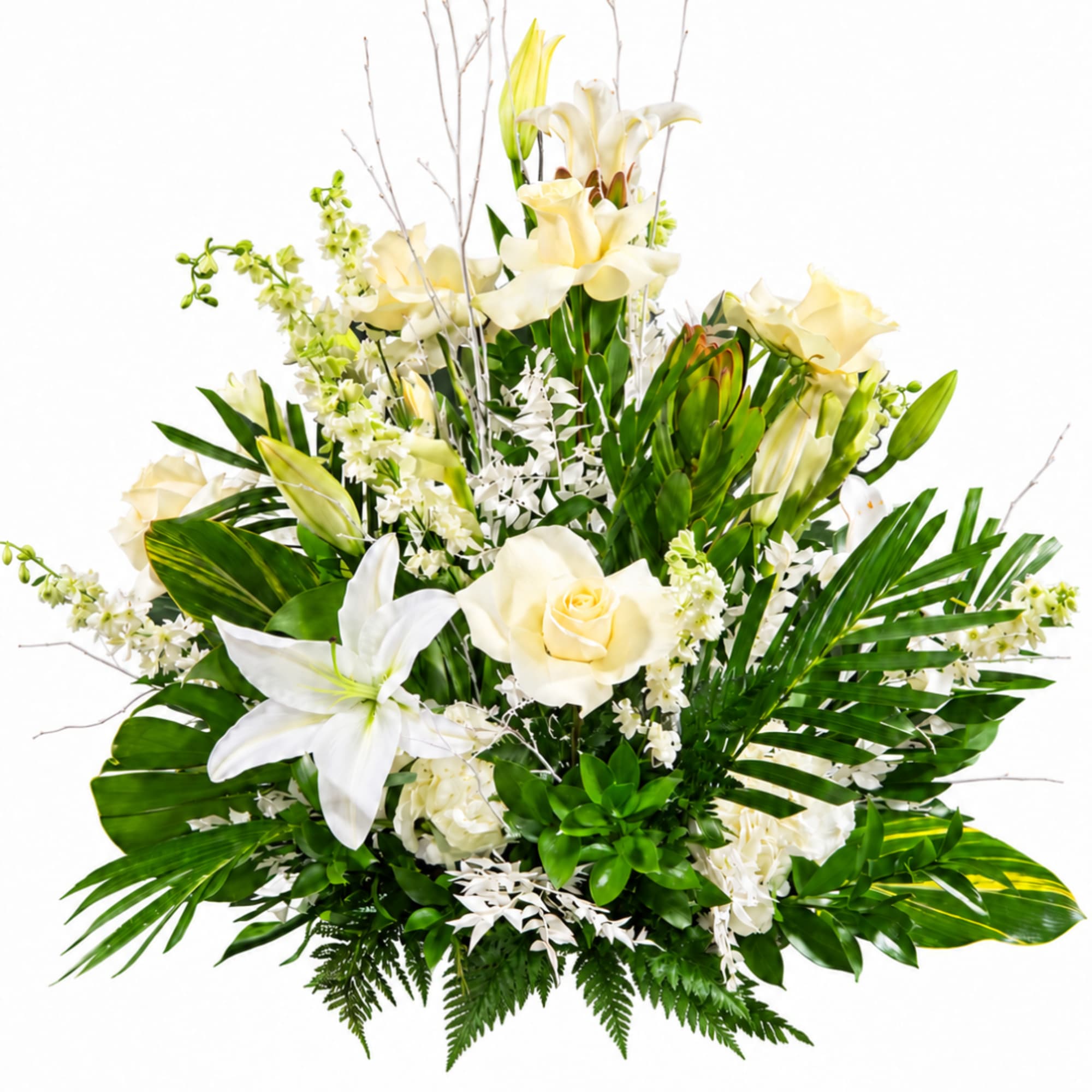 White lilies and cream roses in a lush green arrangement