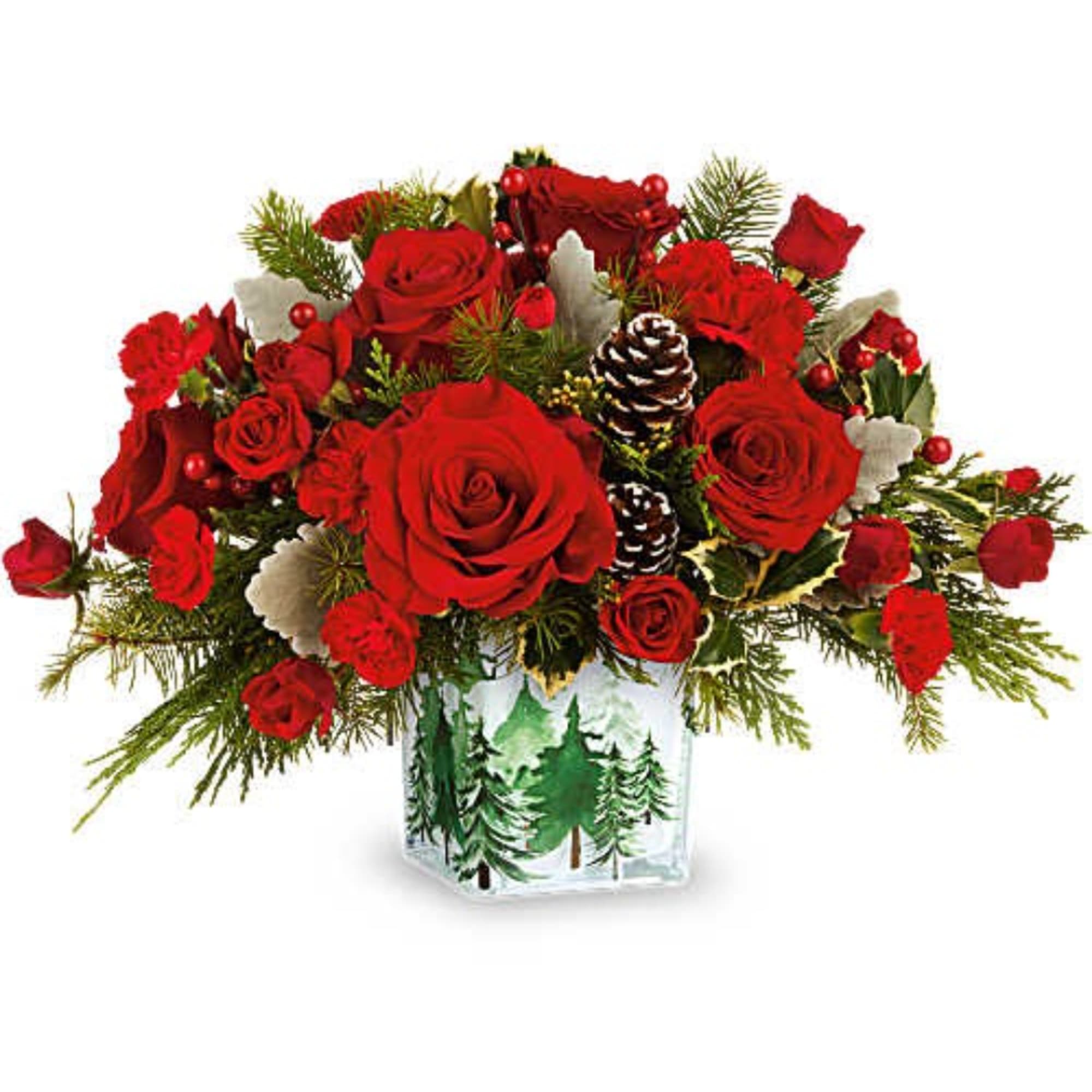 Red roses in a glass vase with pinecones and holiday greenery