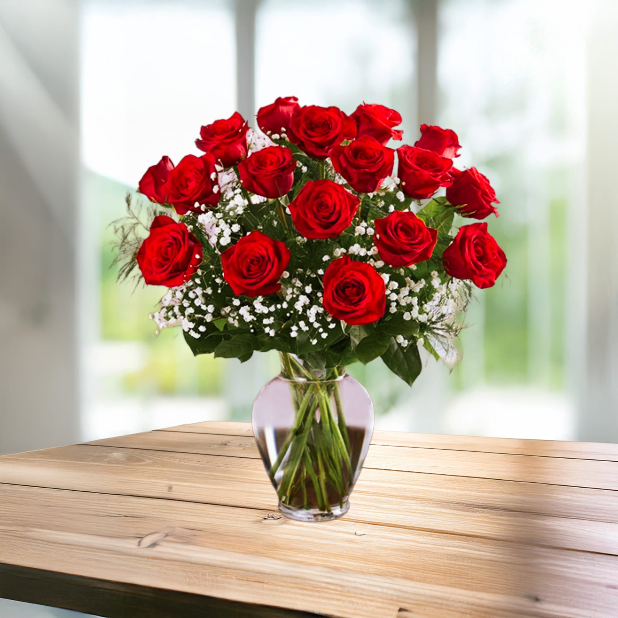 Red roses arranged in a clear glass vase