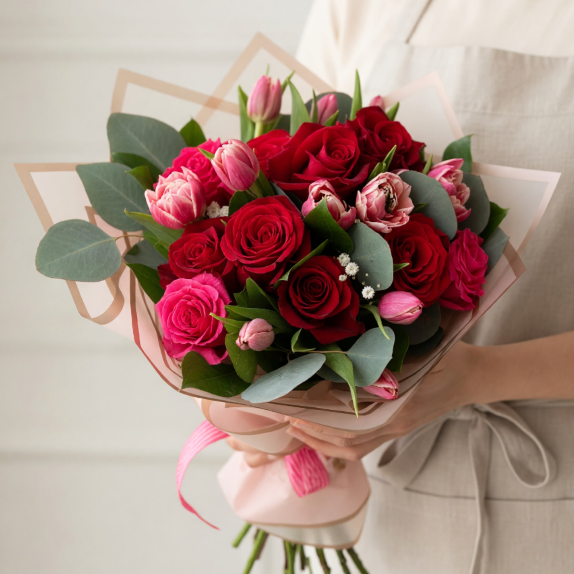 This elegant bouquet brings together the timeless beauty of lush red roses
