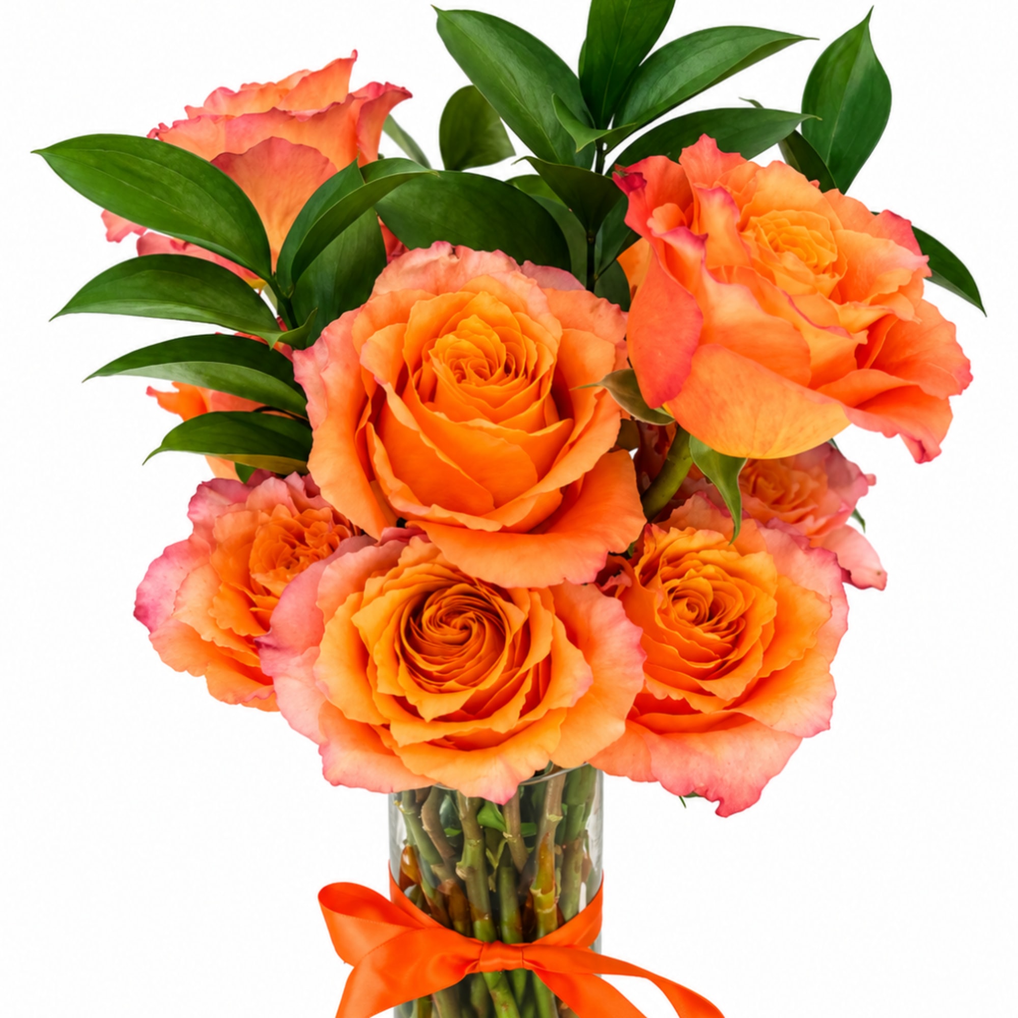 Orange roses in a clear glass vase with a ribbon