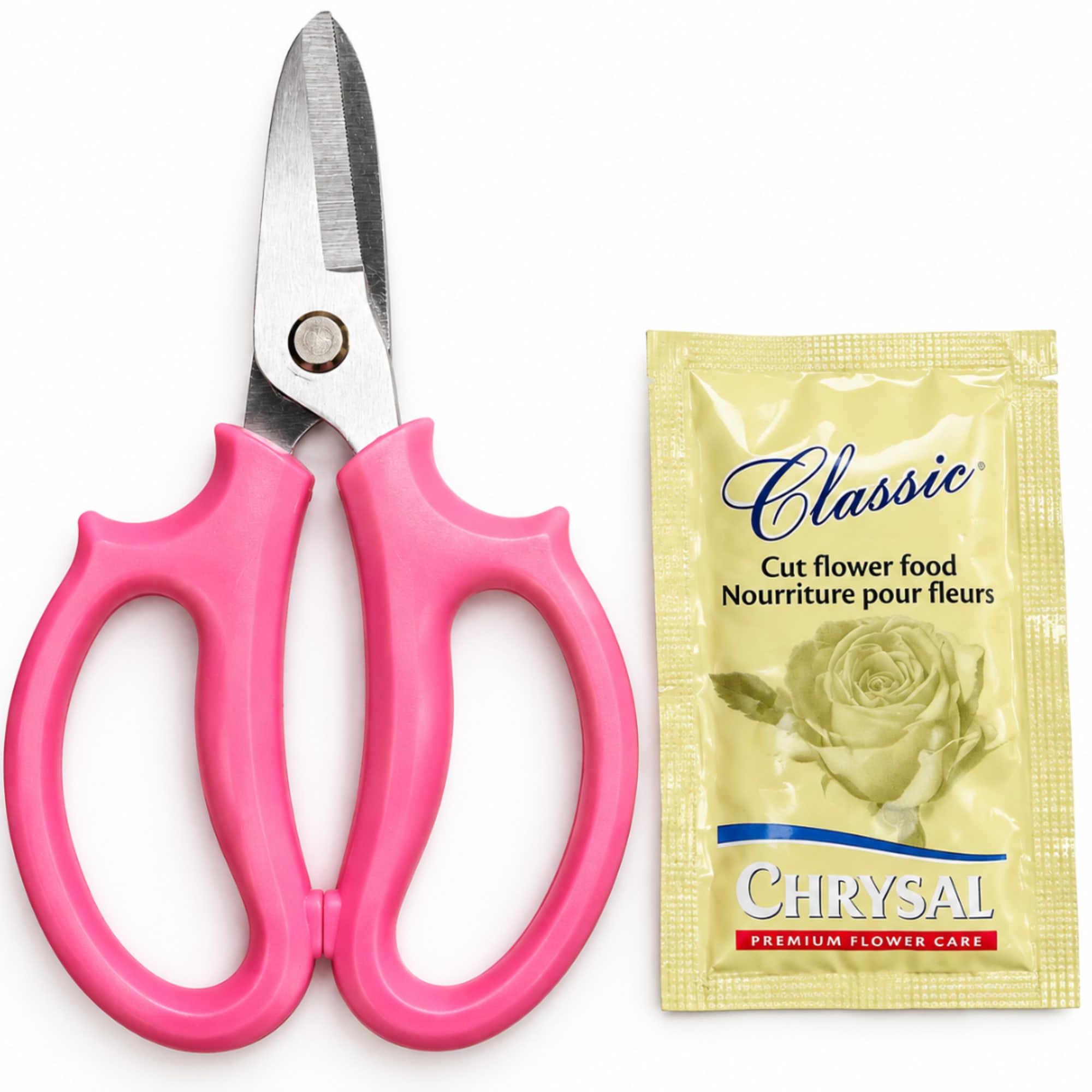 Pink-handled floral snips beside a packet of cut flower food