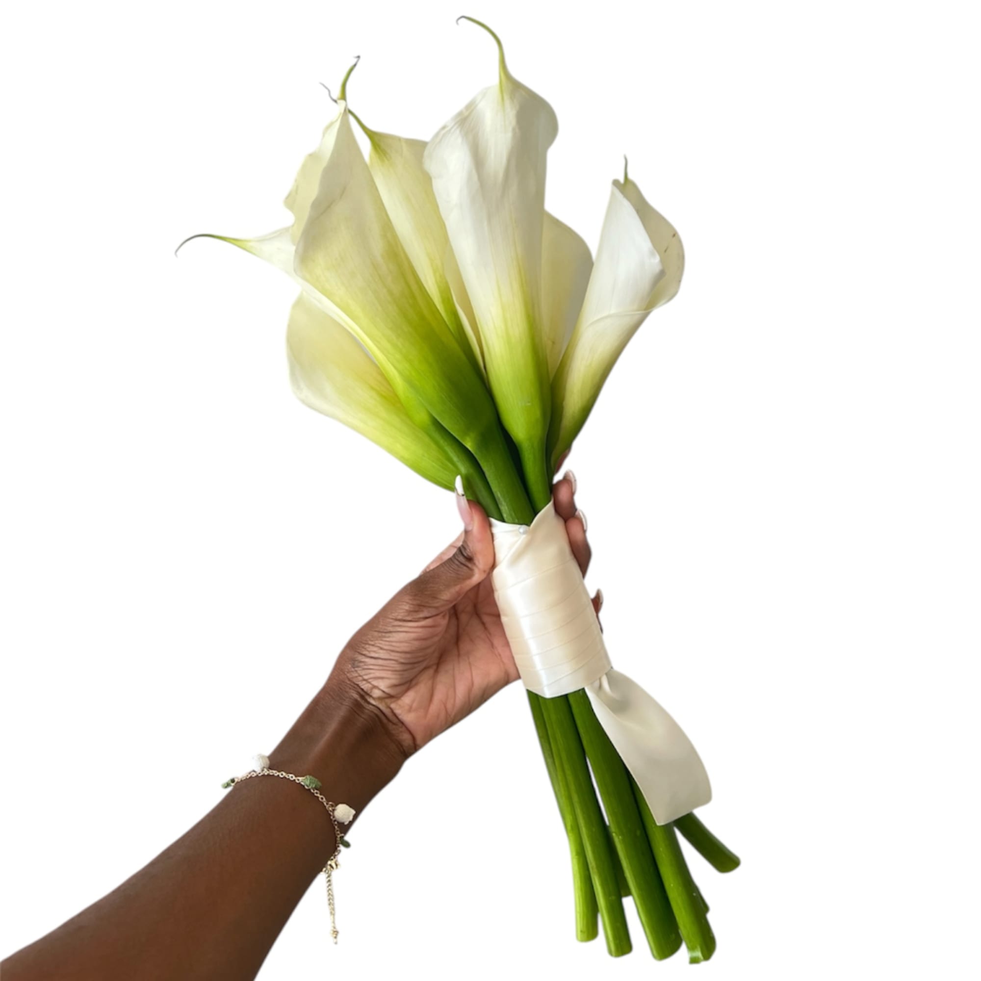 Hand holding a white calla lily bouquet tied with satin ribbon