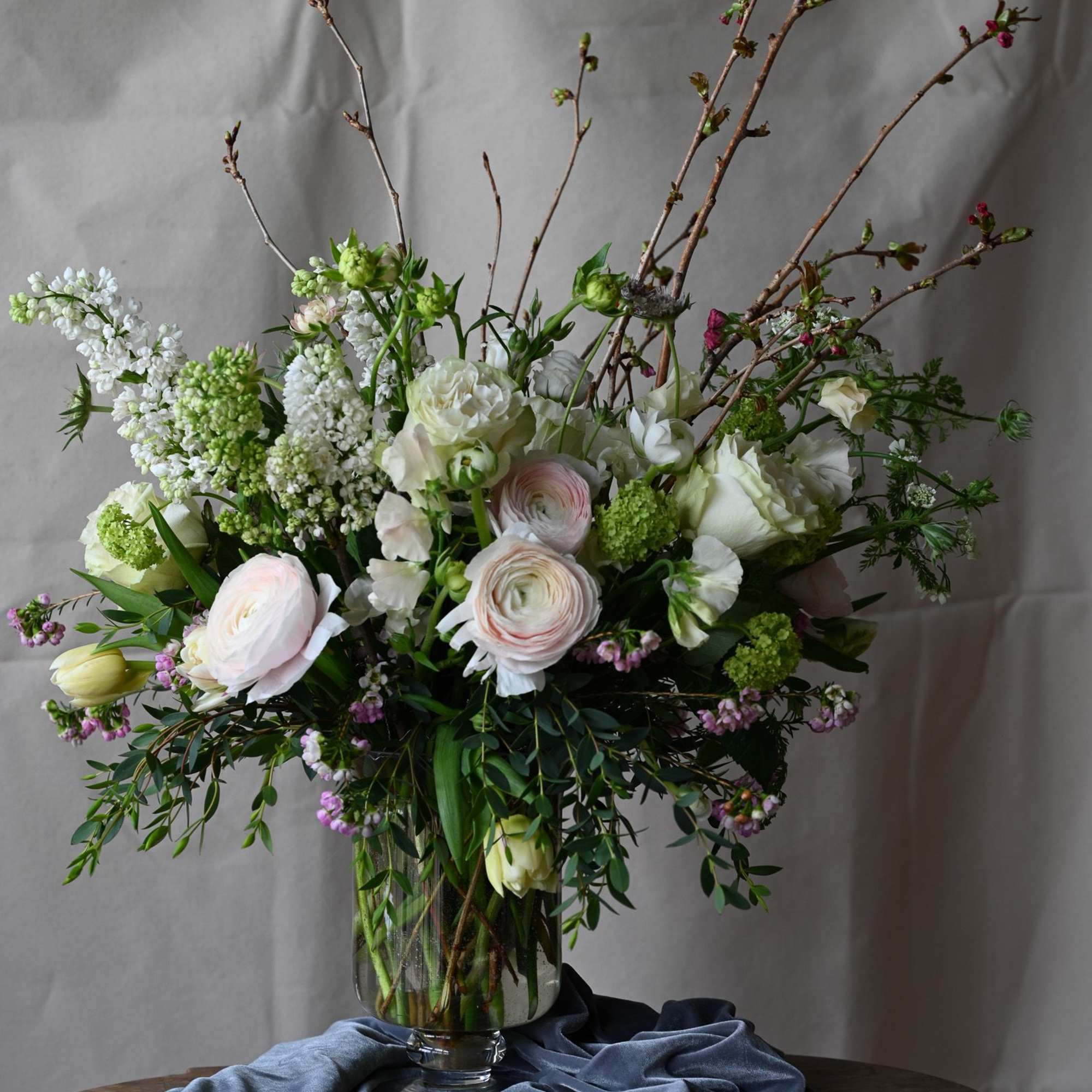 Flowering branches of lilac, cherry blossom, premium ranunculus, garden roses as well