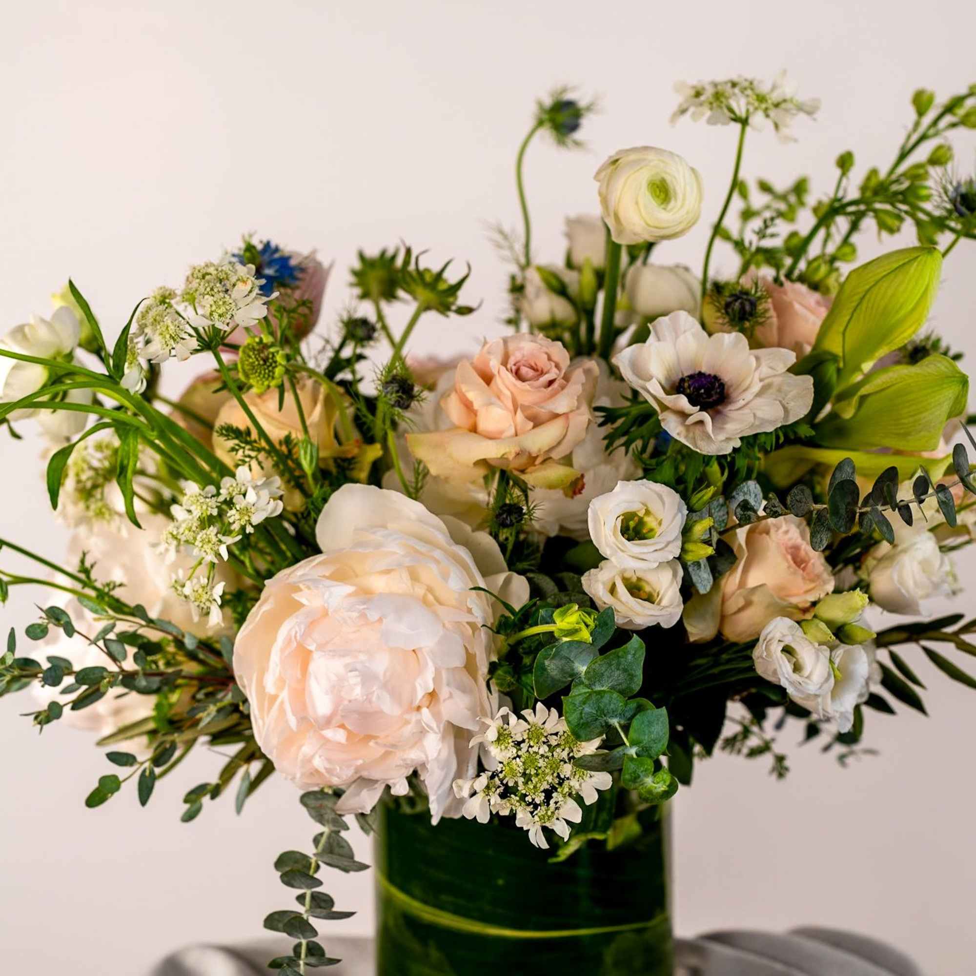 Peaceful and soft shades of beautiful blooms enhance this lovely design and