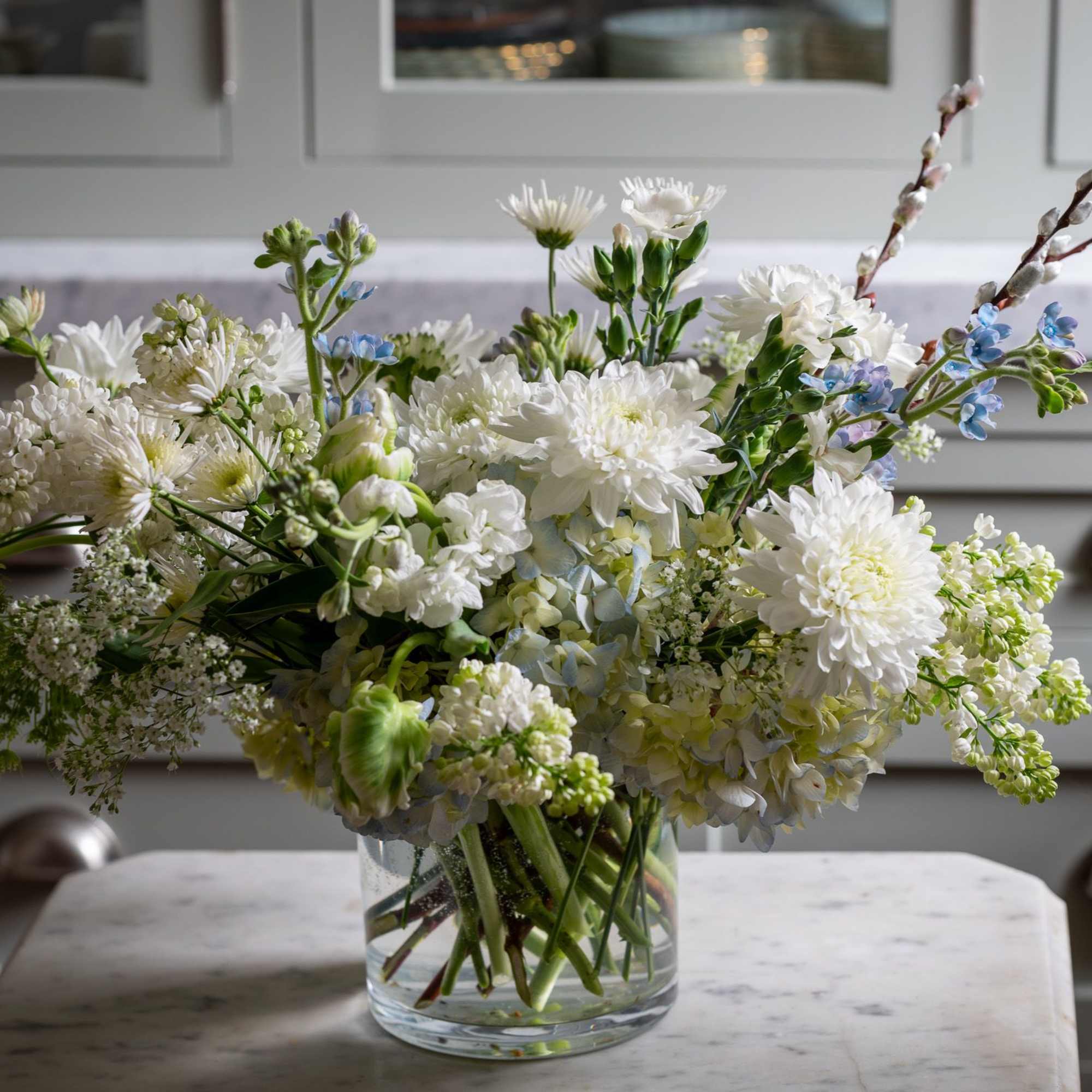Timeless and classic in white and green a beautiful low standing centerpiece