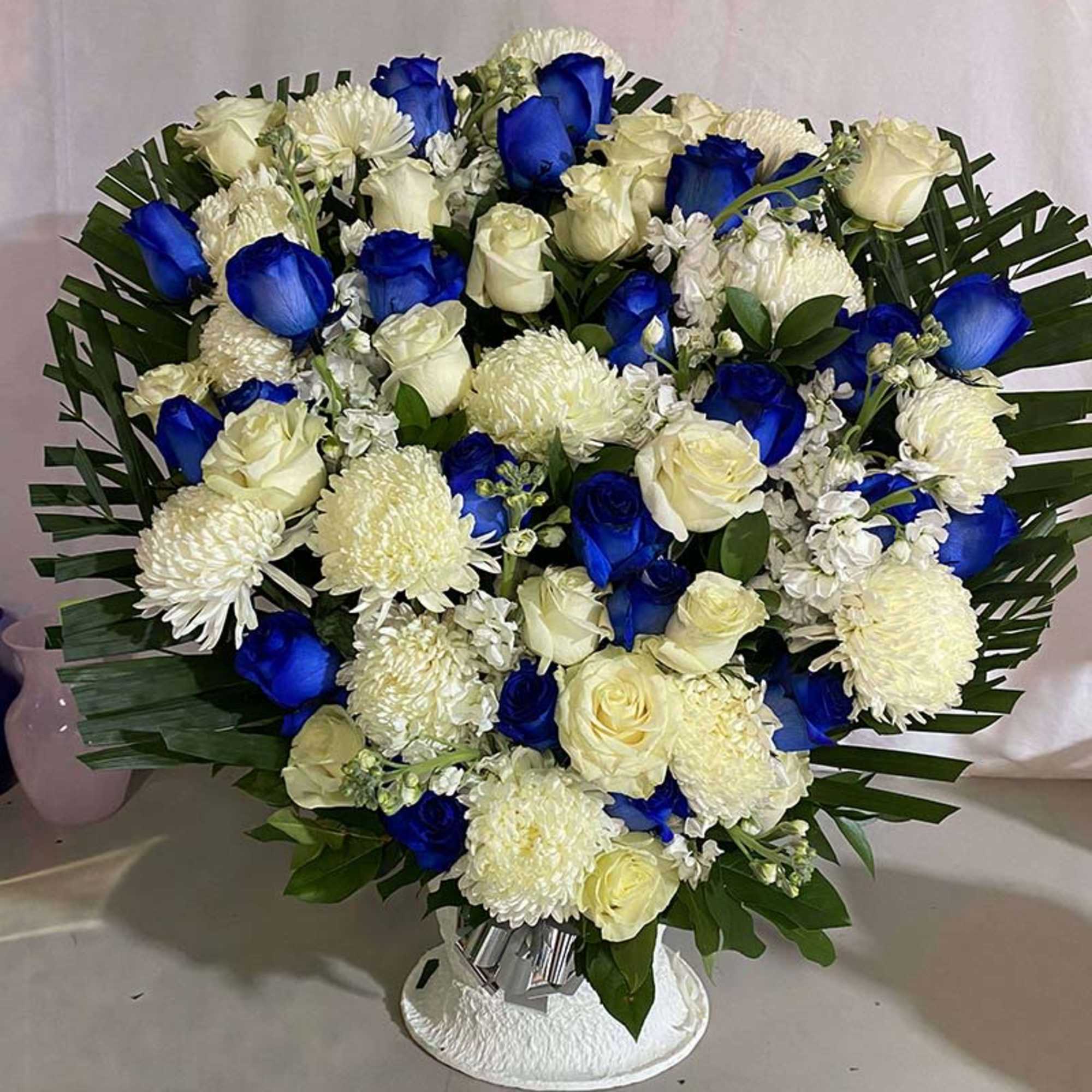 Blue and white rose bouquet with white chrysanthemums in a vase