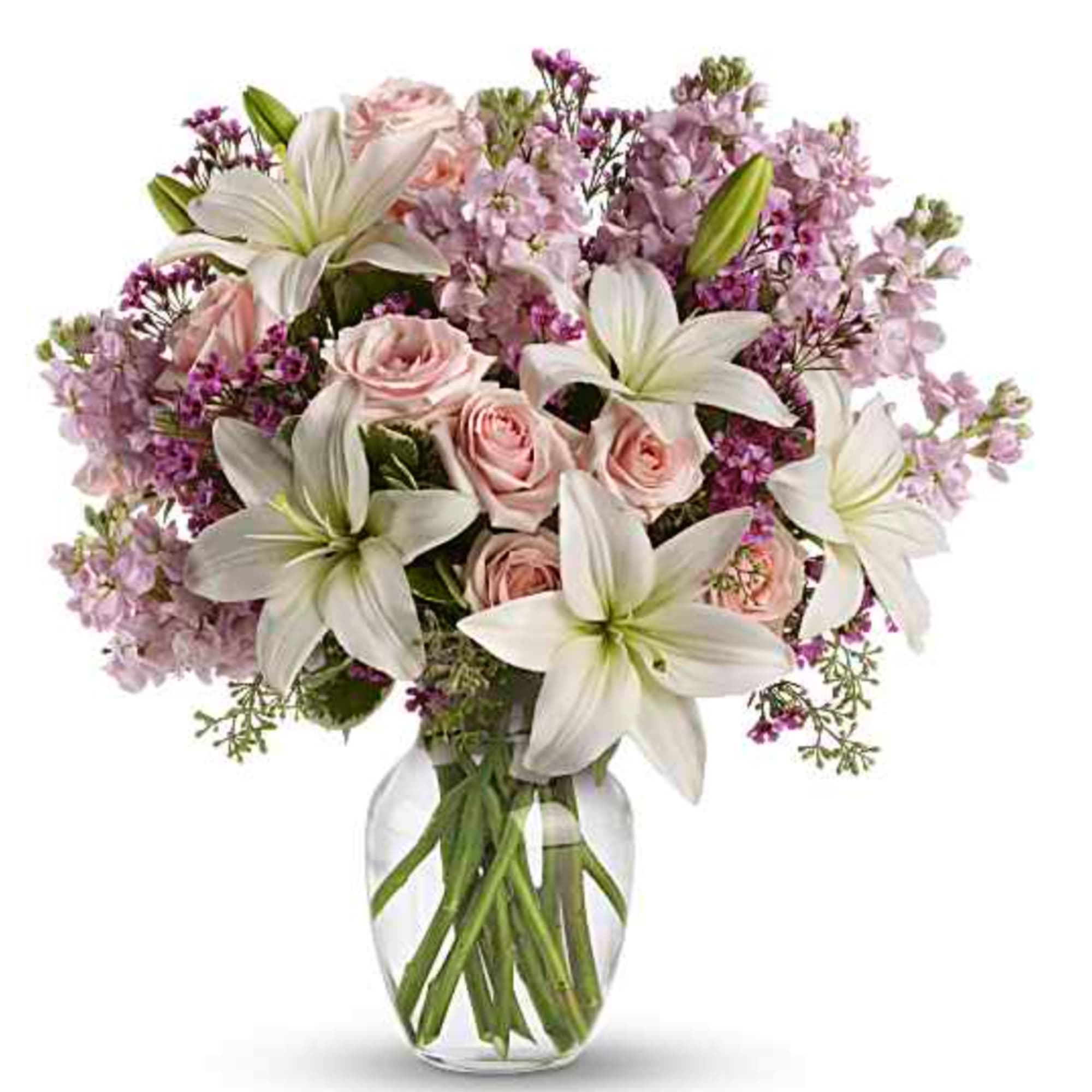 Pink roses and white lilies arranged in a clear glass vase