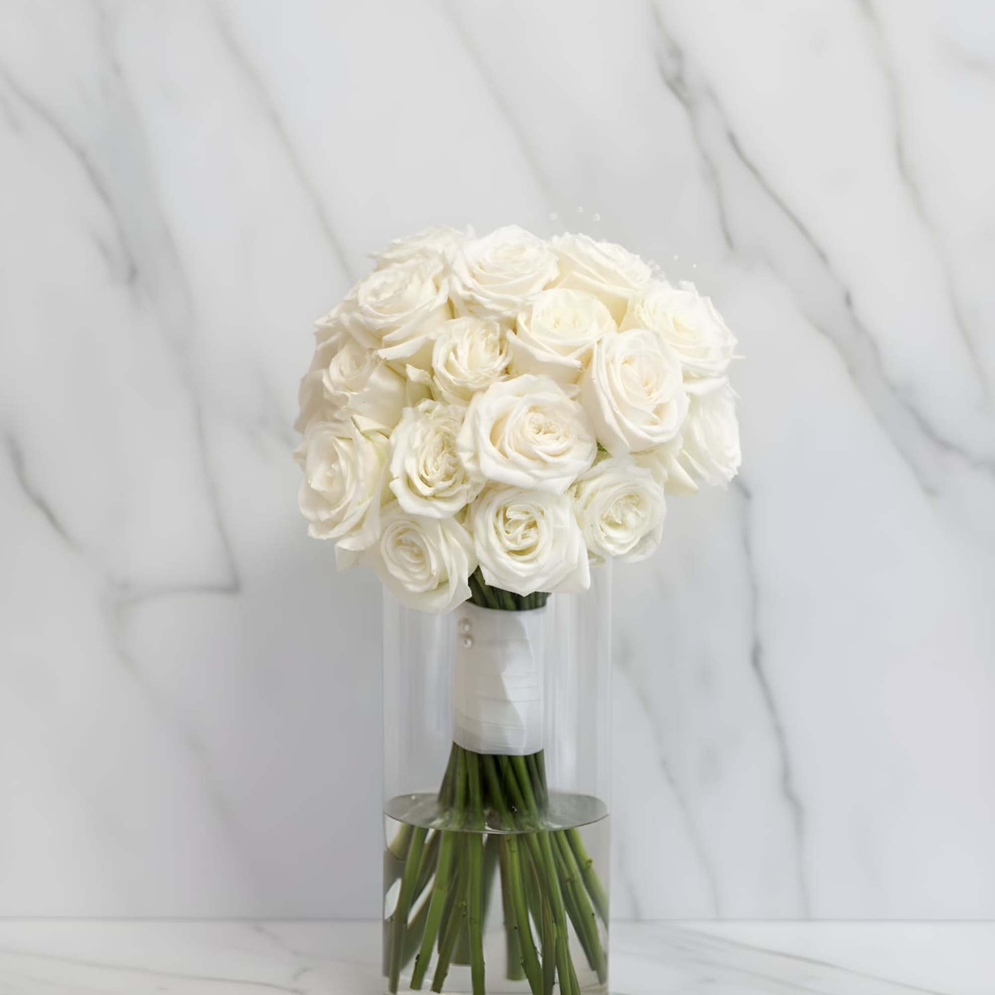 Graceful, timeless, and beautifully refined, this elegant bridesmaid bouquet features fresh white