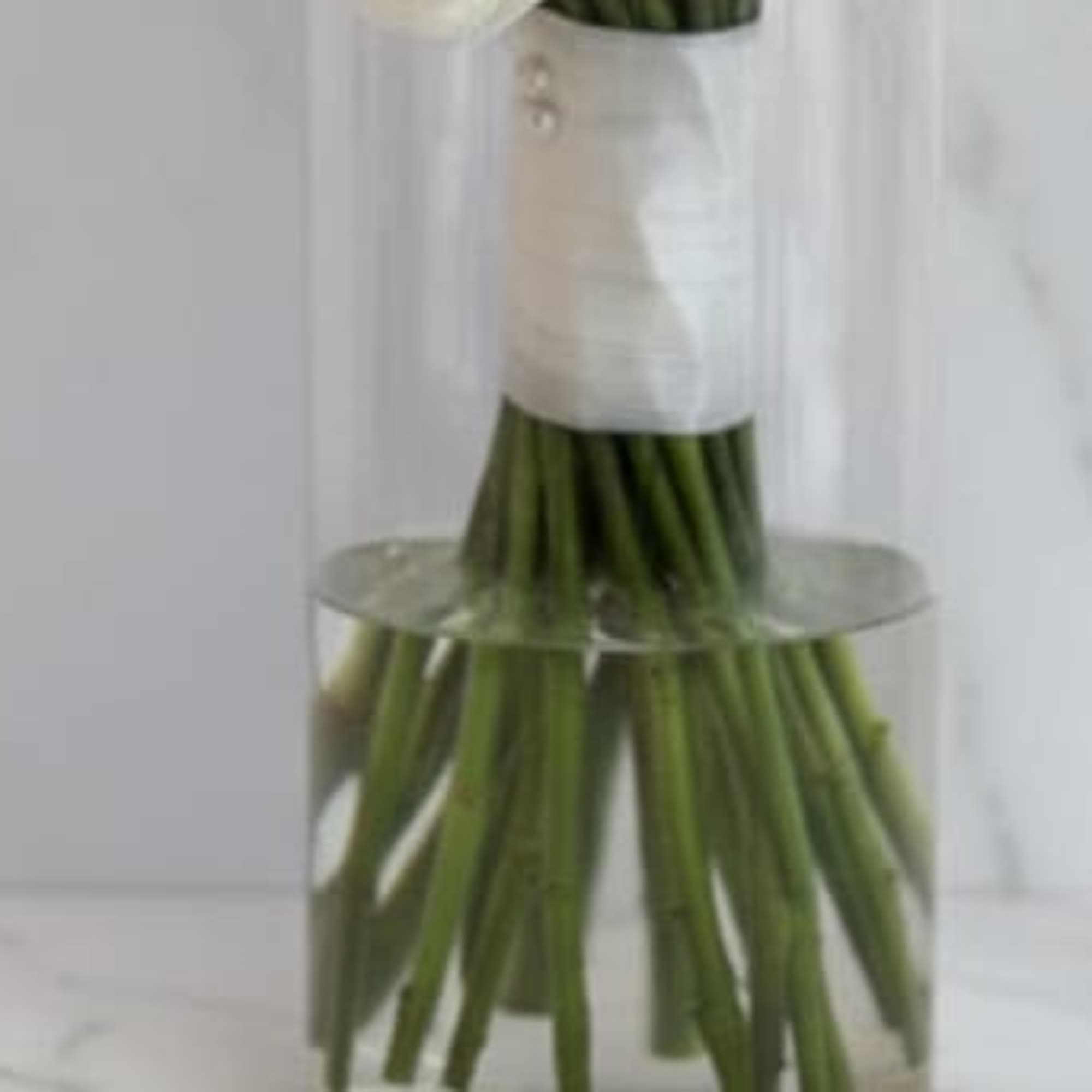 Graceful, timeless, and beautifully refined, this elegant bridesmaid bouquet features fresh white, photo 2 of 2