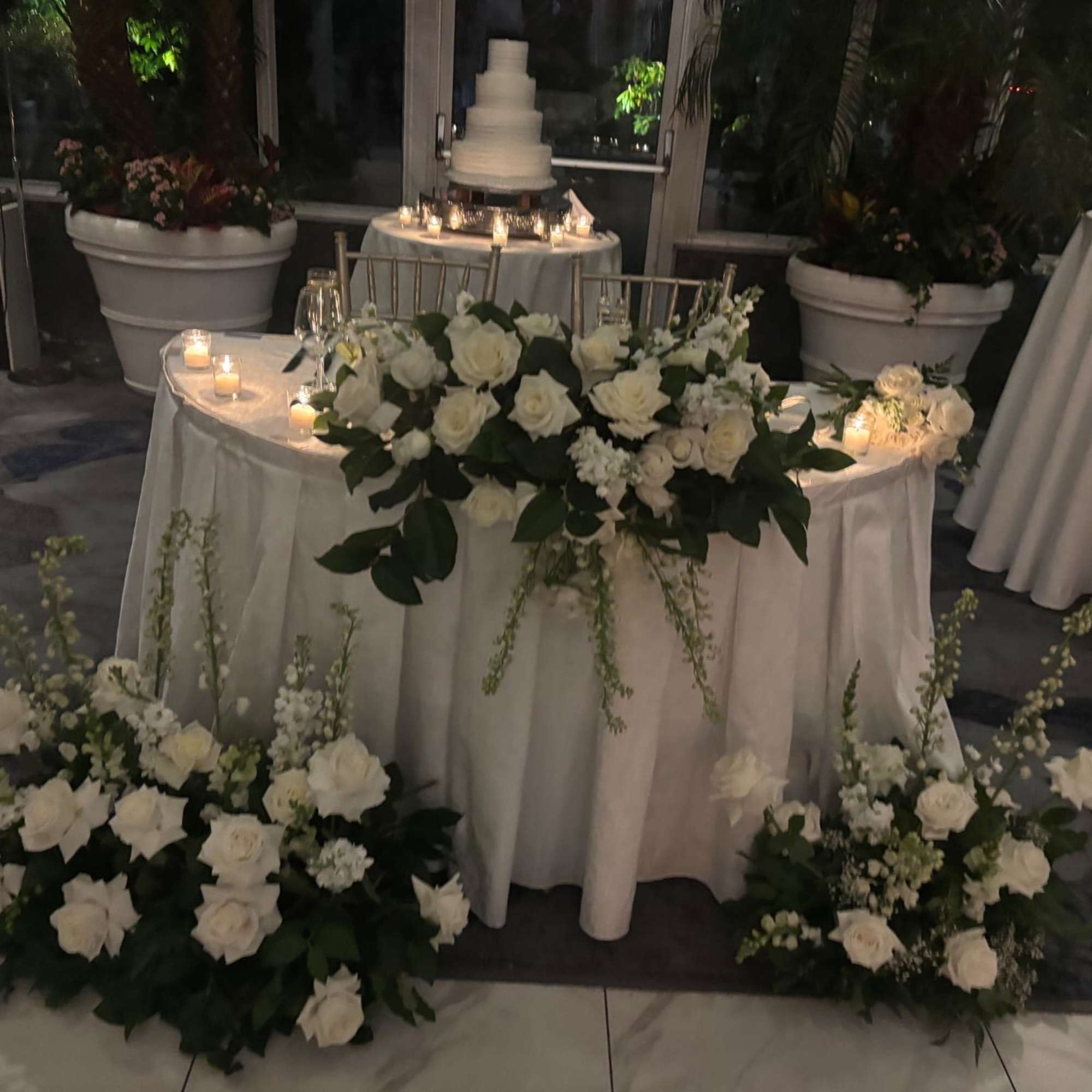 This romantic swetheart table meade with fresh white blooms, including roses, chrysanthemums, photo 2 of 2