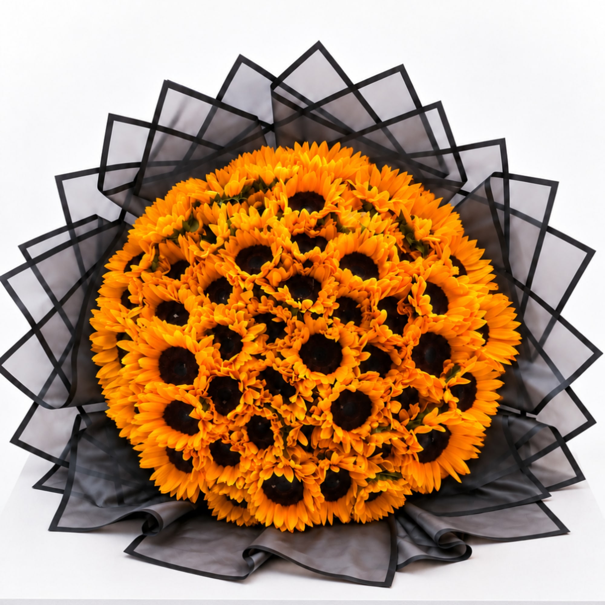 Bouquet of orange sunflowers wrapped in black paper