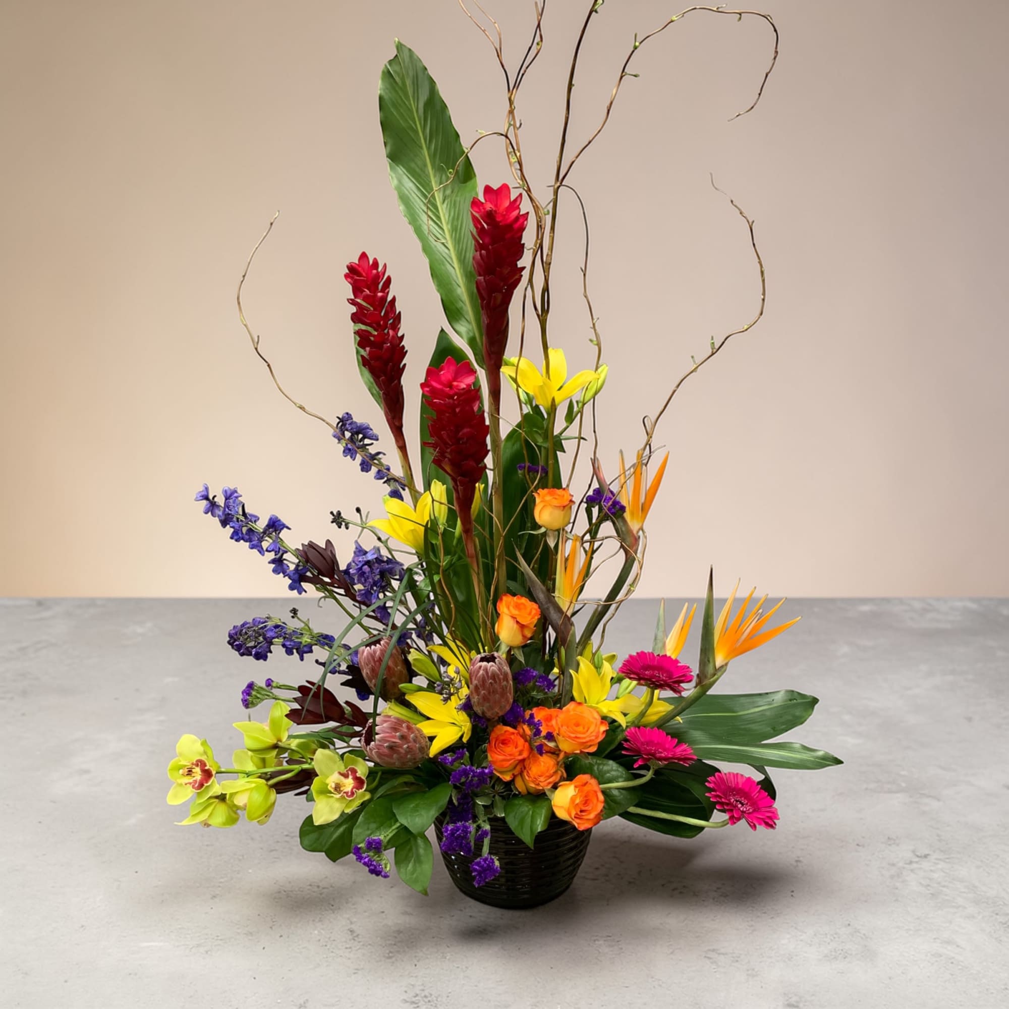 A dramatic tower of red ginger spikes and birds of paradise rises