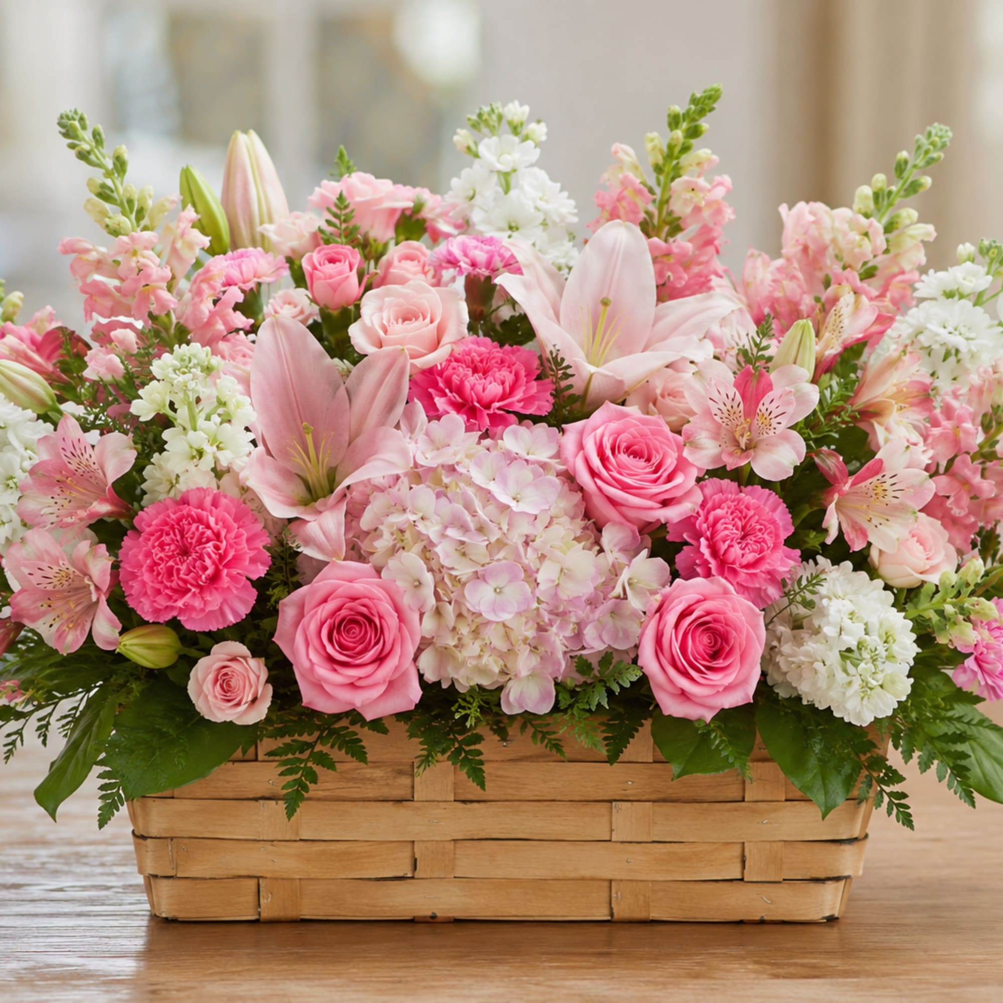 Soft pastels and a rustic woven basket make this flower arrangement an