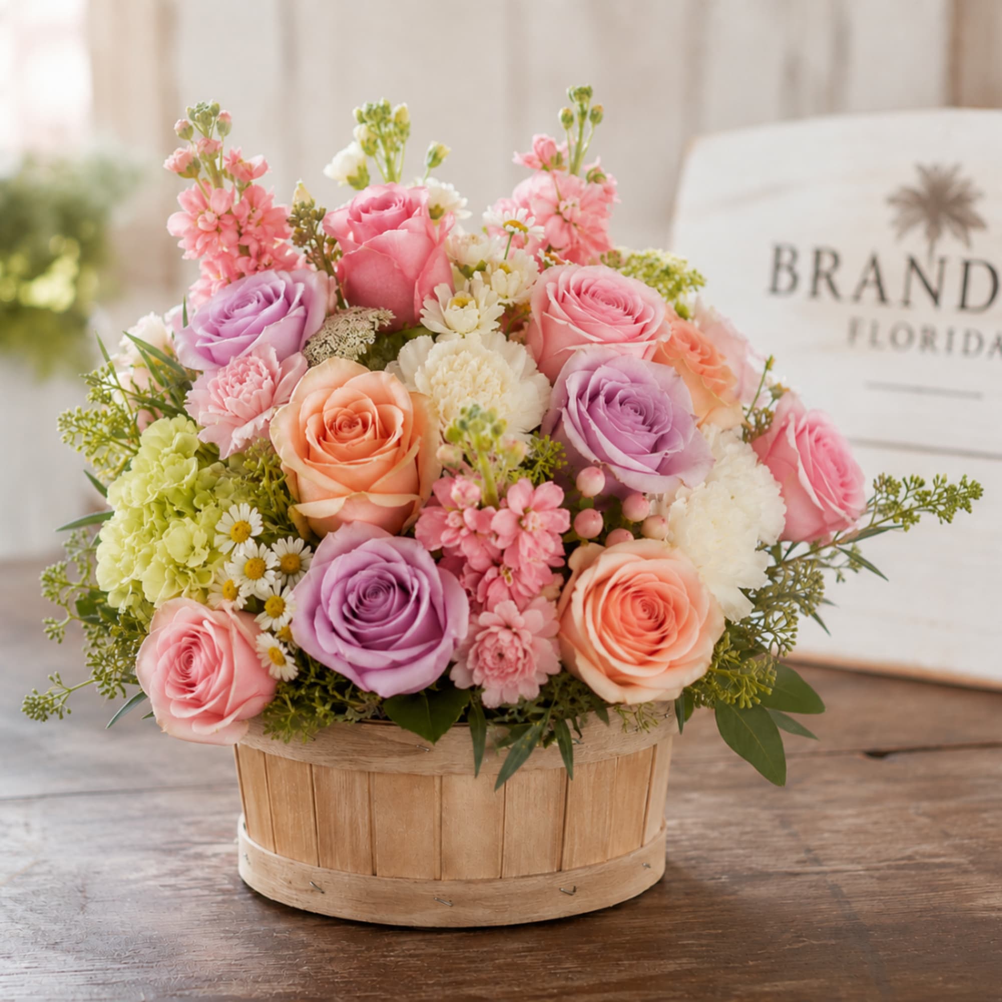 Pastel rose bouquet in a round wooden basket