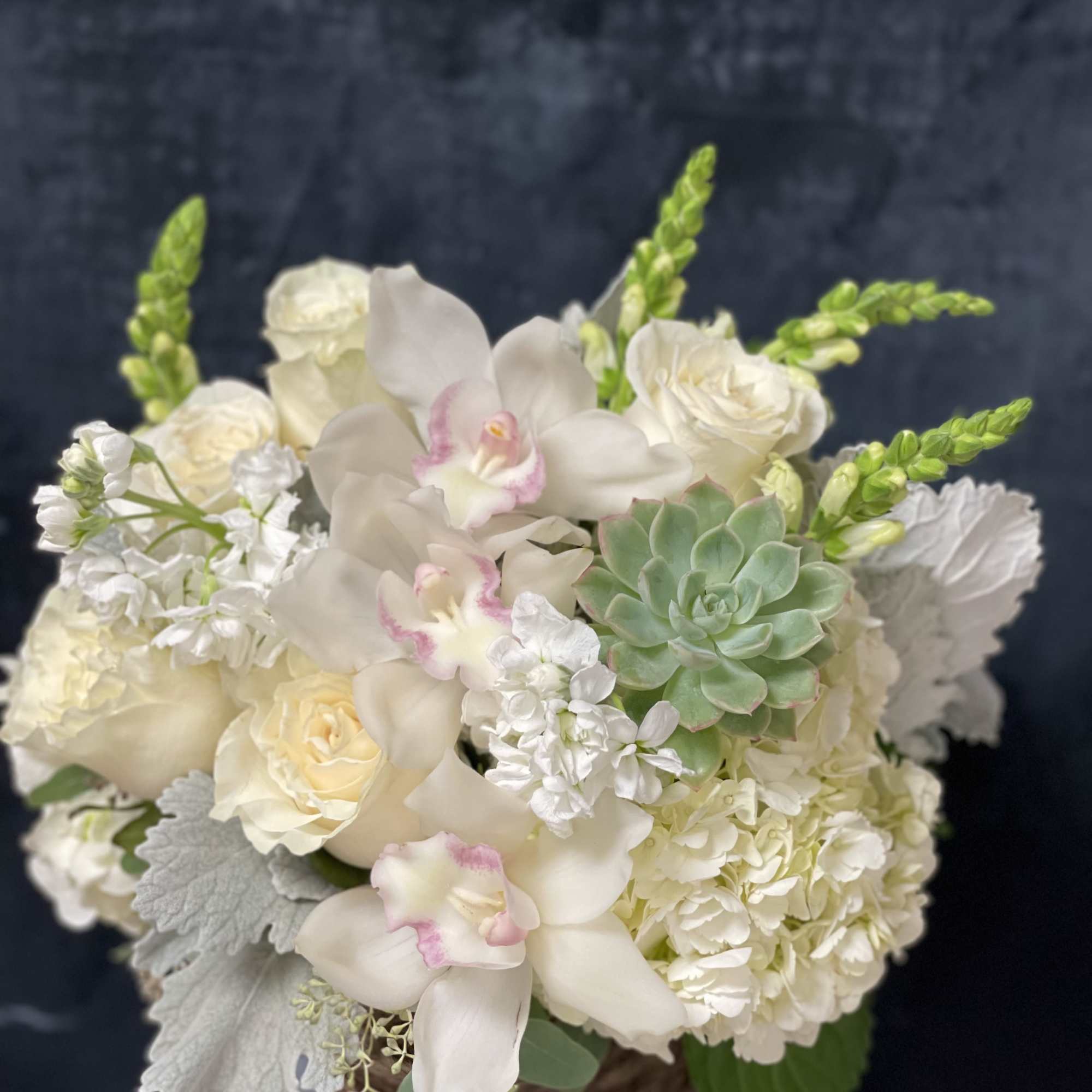 White hydrangeas, white roses, white snapdragons, white cymbidium, white stock, succulent and, photo 2 of 2