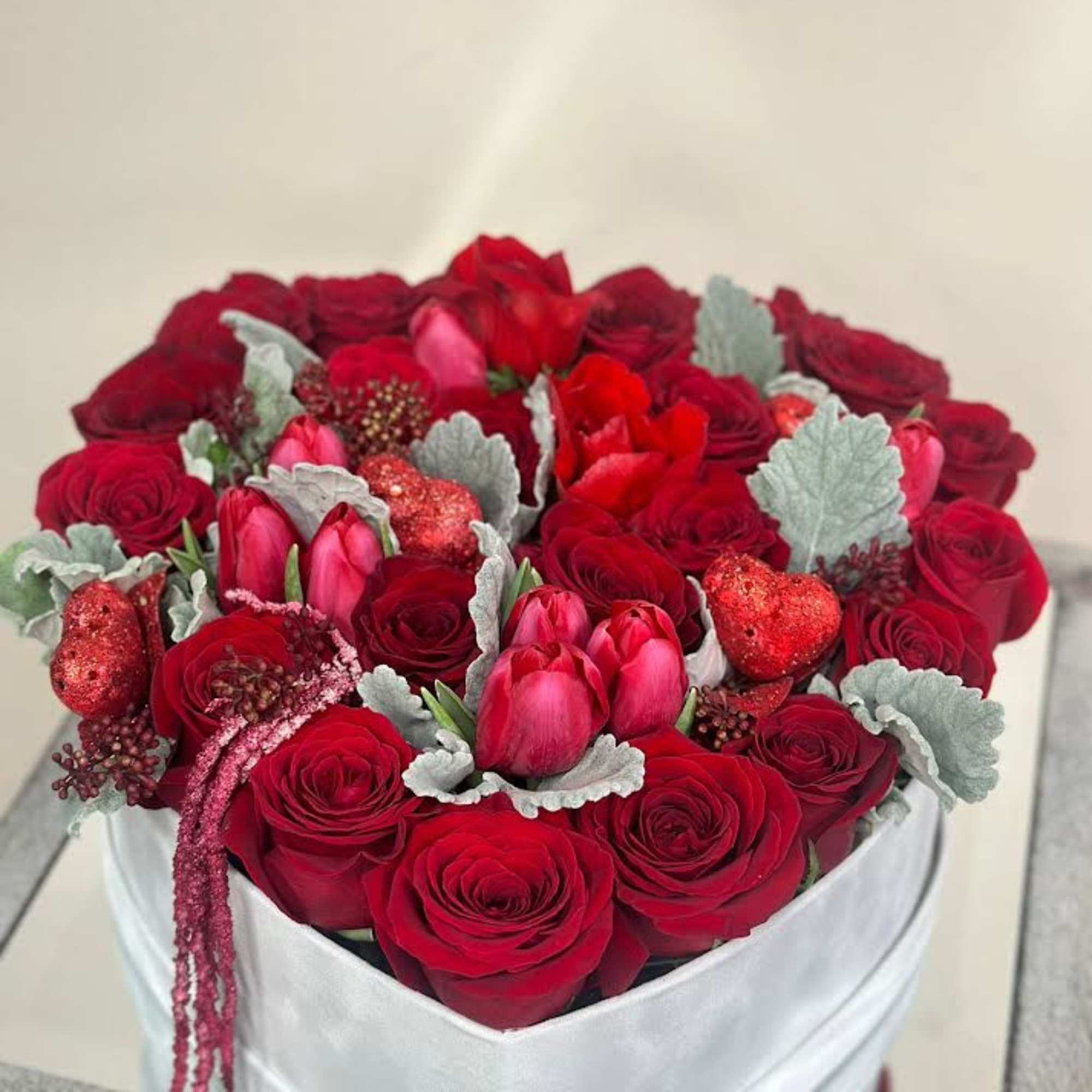 A bright and cheerful arrangement of red , inspired by the beauty