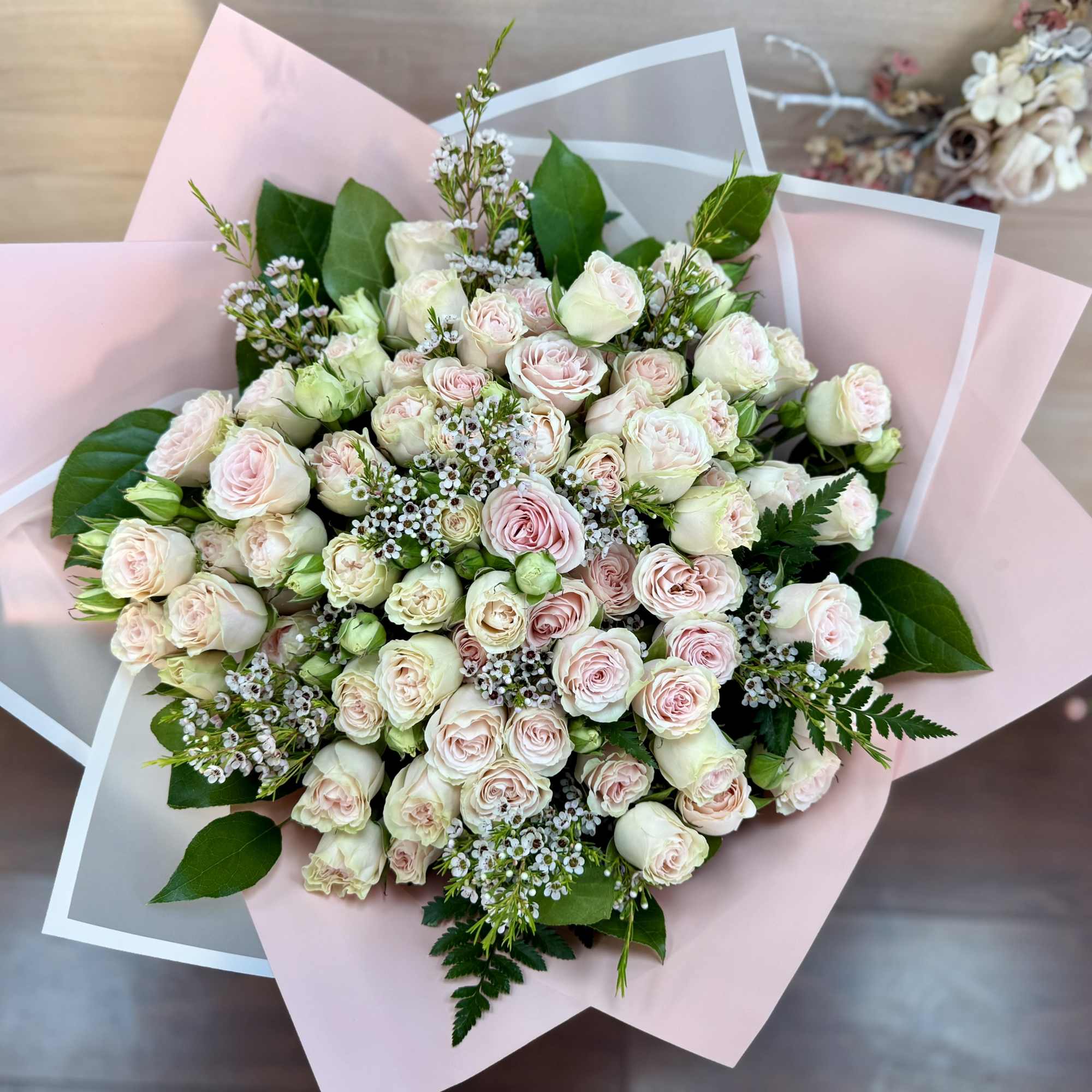 An elegant floral arrangement featuring a blend of pure white and vibrant
