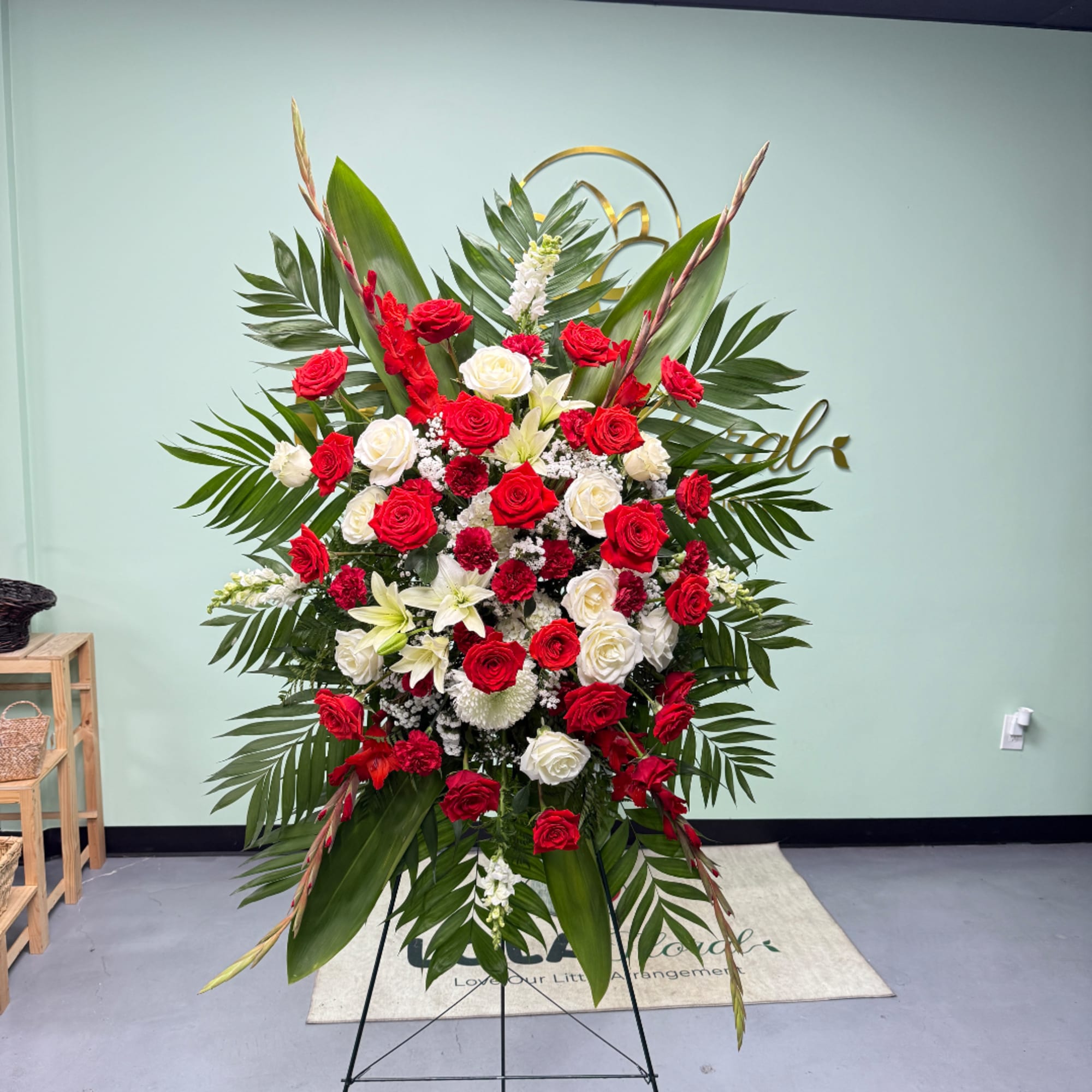 Large standing floral spray with red and white roses and lilies