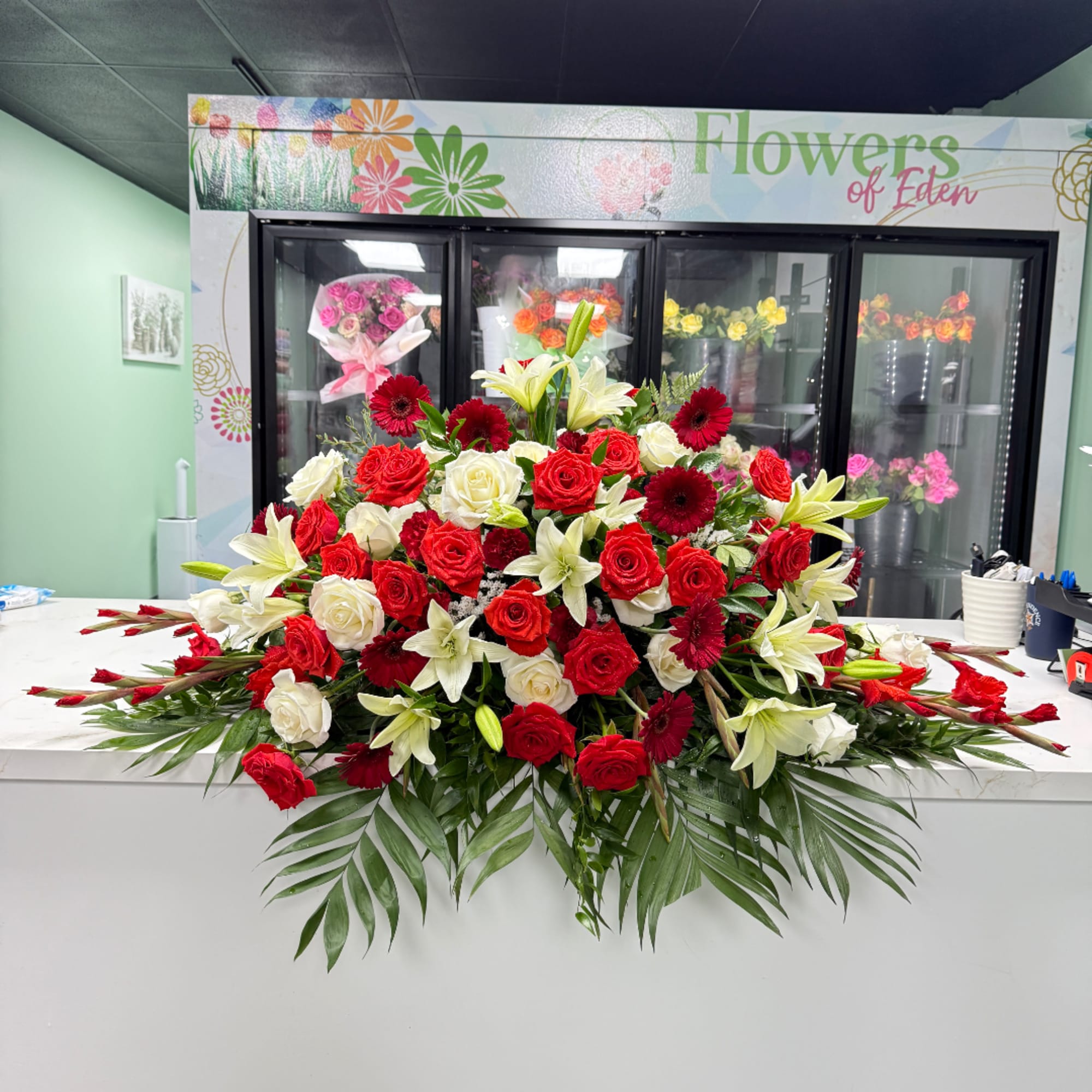 Large red and white rose arrangement with lilies and gerbera daisies