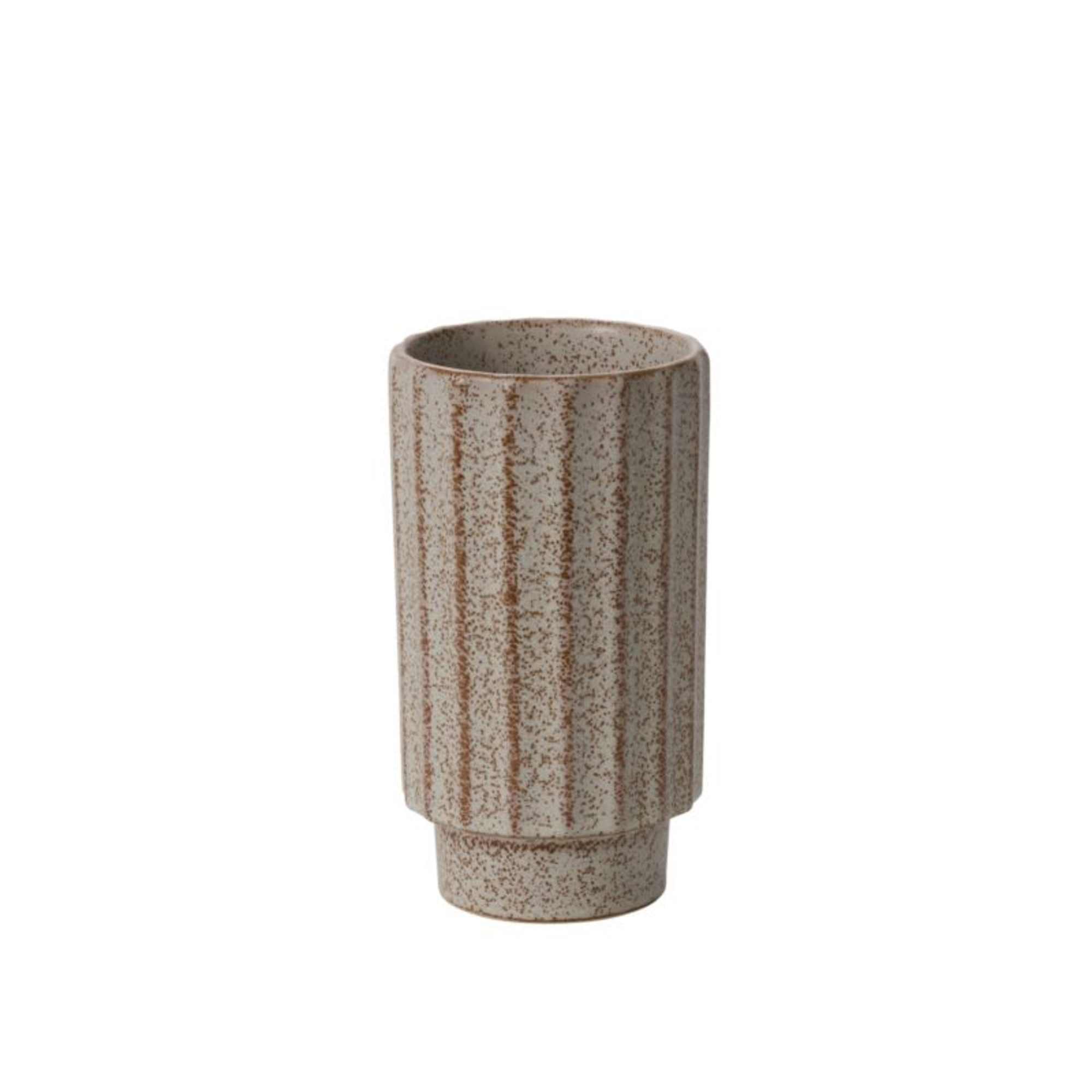 A speckled ceramic vase in warm beige and brown with ribbed rustic