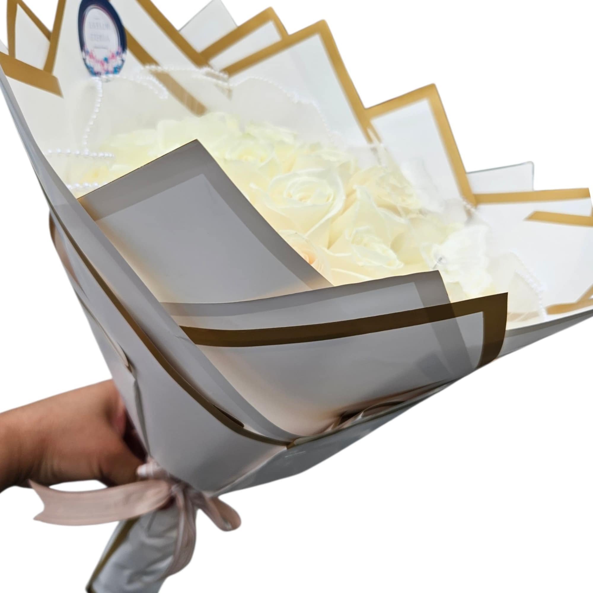 White  roses are tightly gathered into a classic rounded hand-tied bouquet, photo 3 of 4
