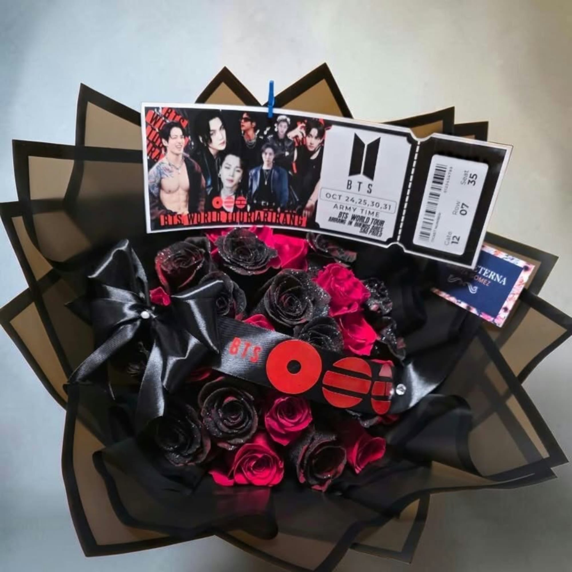 Black and hot pink rose bouquet with BTS-themed ticket cards