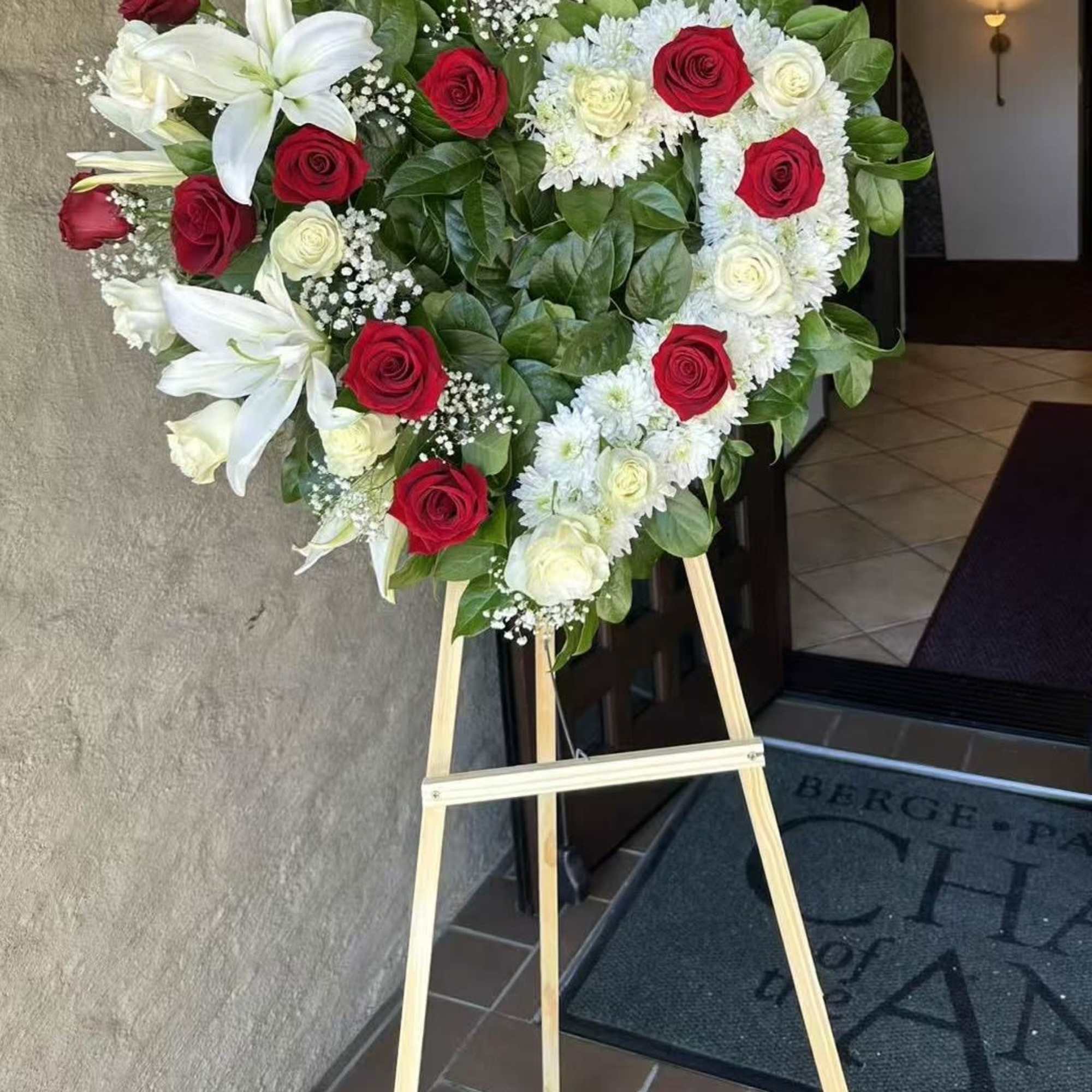 A beautiful heart-shaped arrangement of red and white roses, symbolizing love, respect, photo 3 of 3