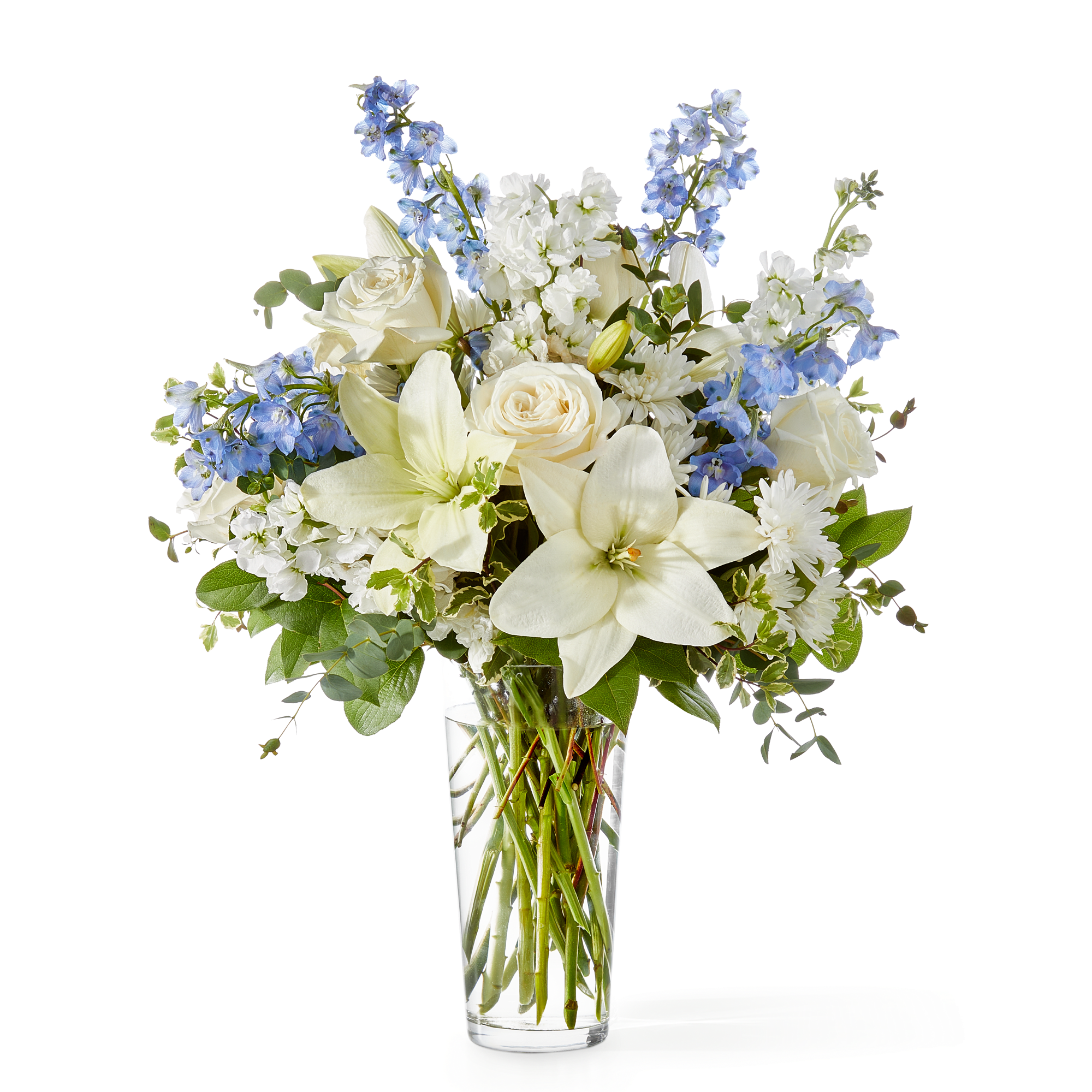An elegant blend of white lilies, roses, and chrysanthemums accented with soft
