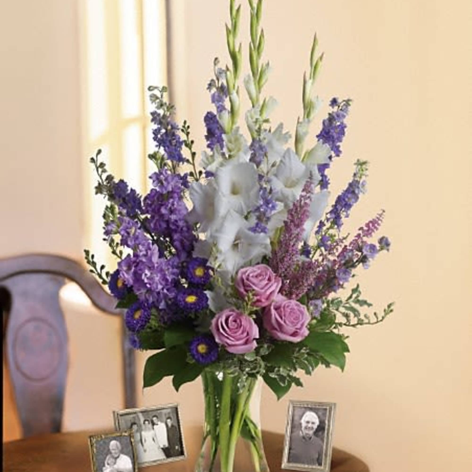 Lavender and white sympathy flowers make a grand statement in this joyful, photo 2 of 2