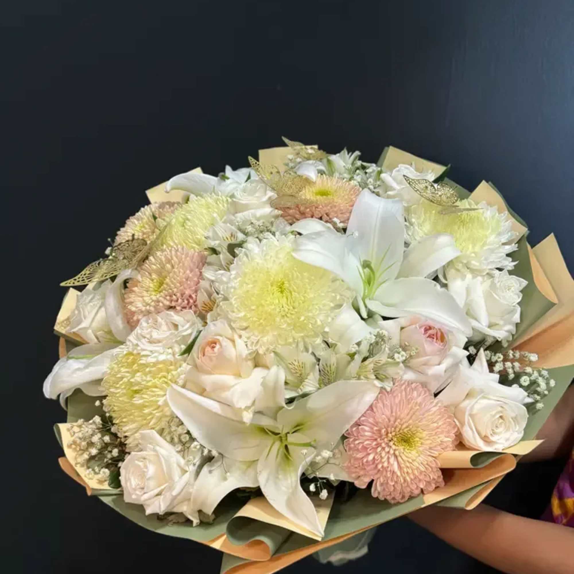 A soft dome of white lilies, creamy roses and pastel chrysanthemums greets, photo 2 of 2