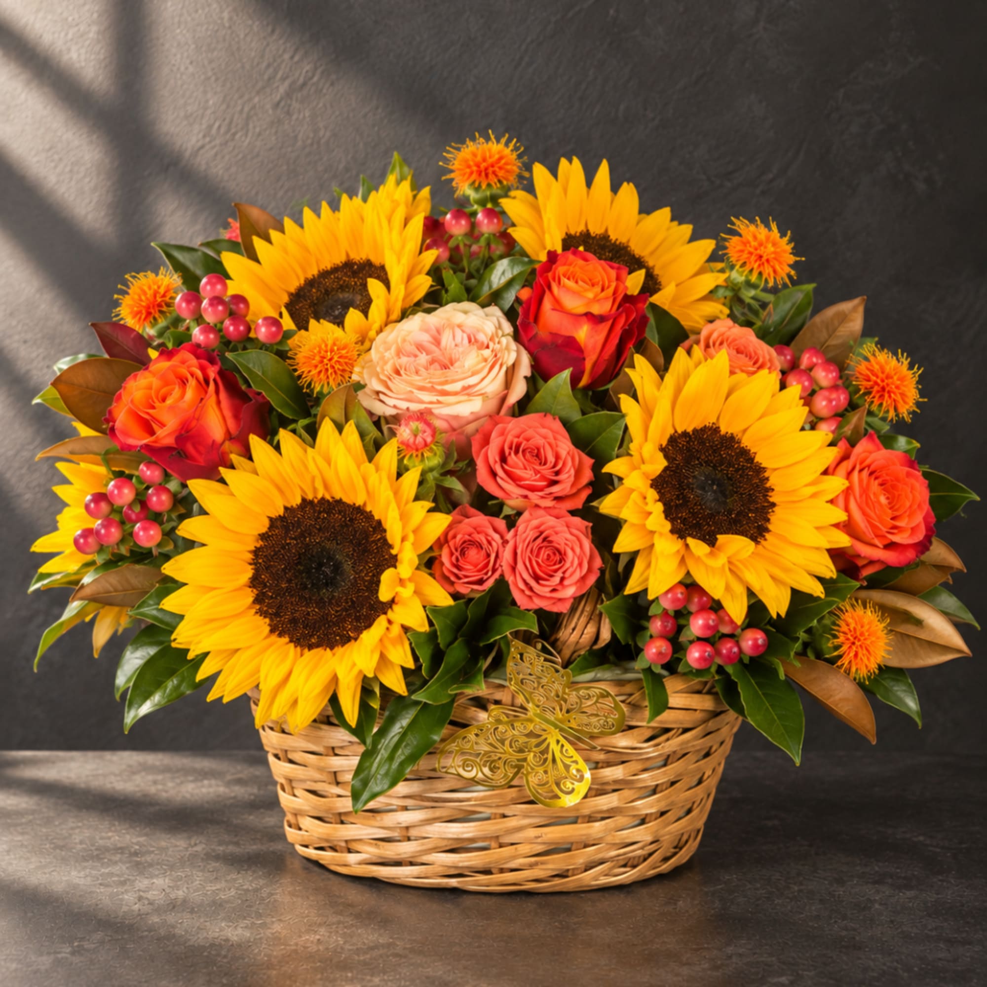 Basket arrangement with sunflowers, roses, and berries