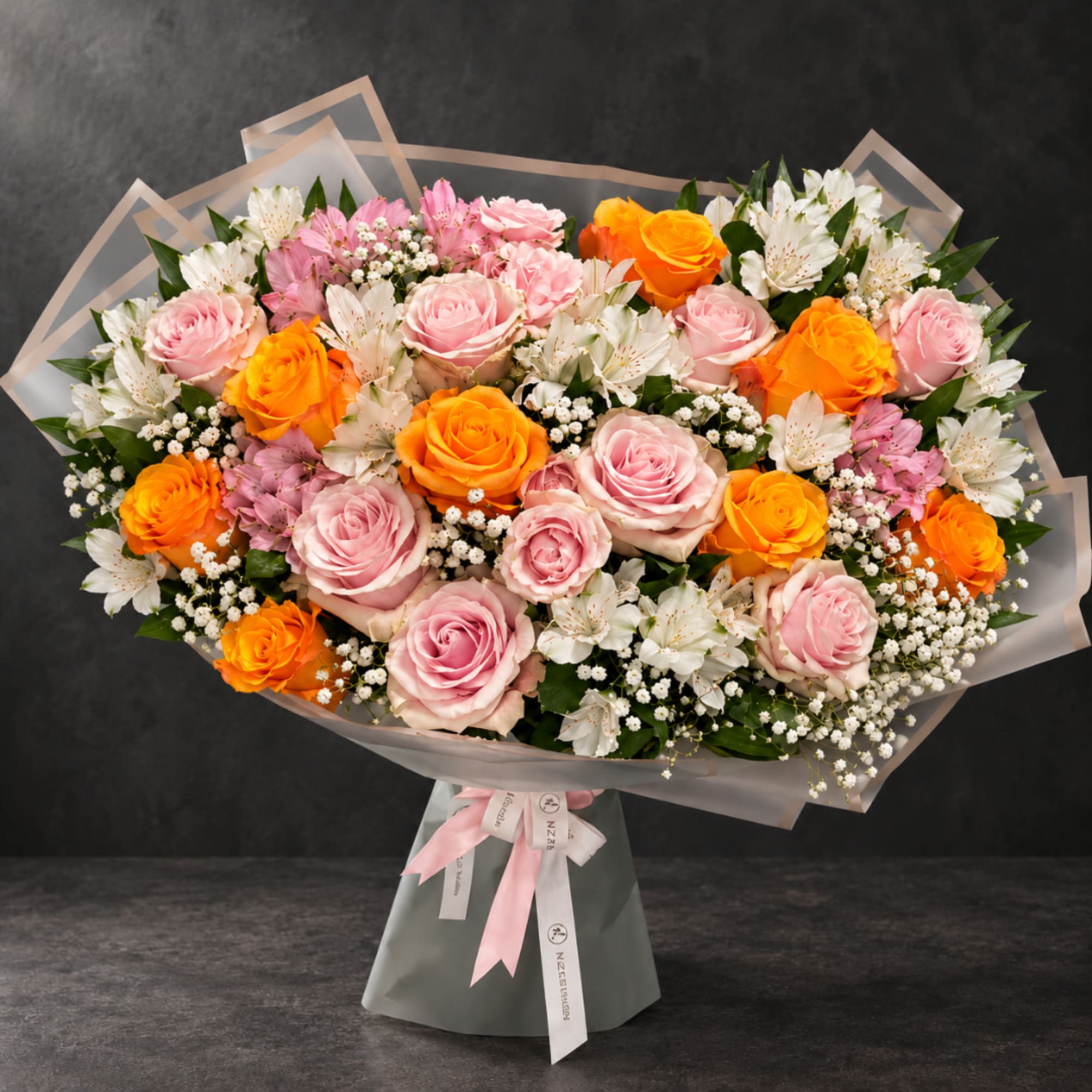 Bouquet of pink and orange roses with white alstroemeria in wrap