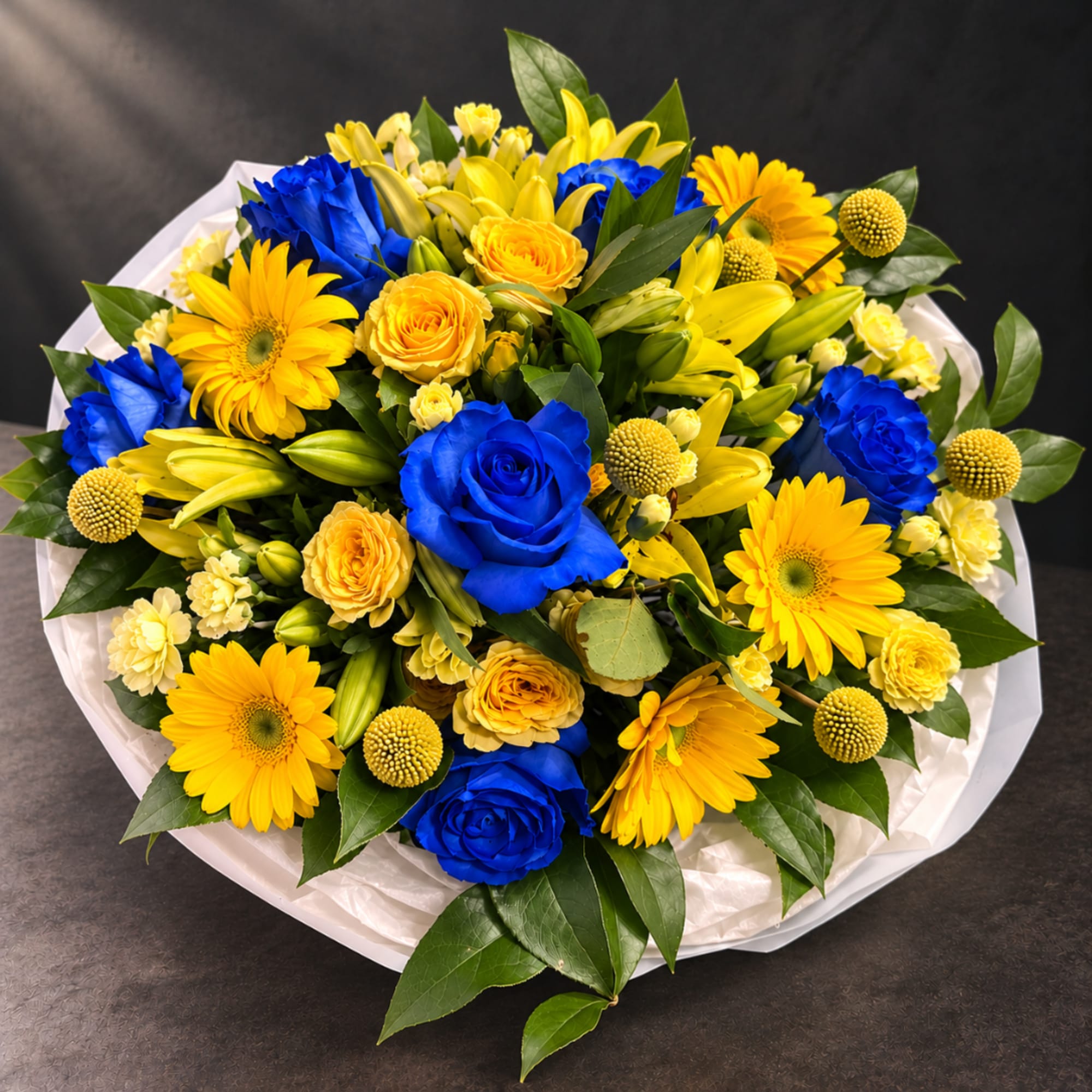 Bouquet of blue and yellow roses with yellow daisies and lilies