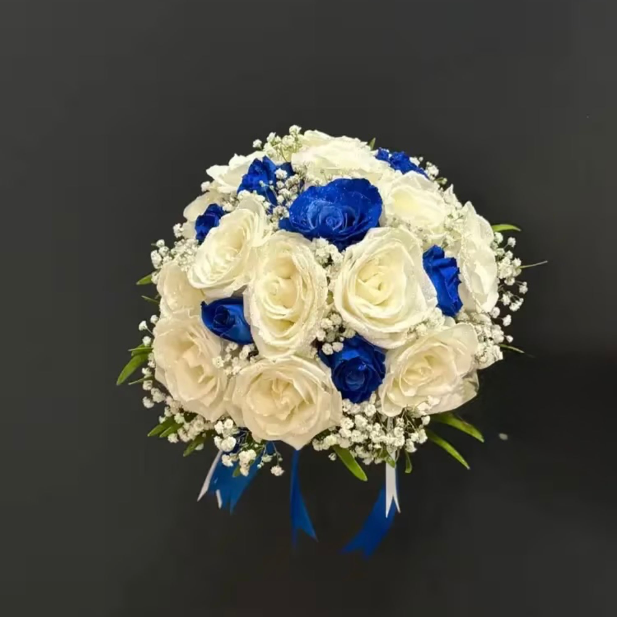 Round bouquet of white and blue roses with baby's breath