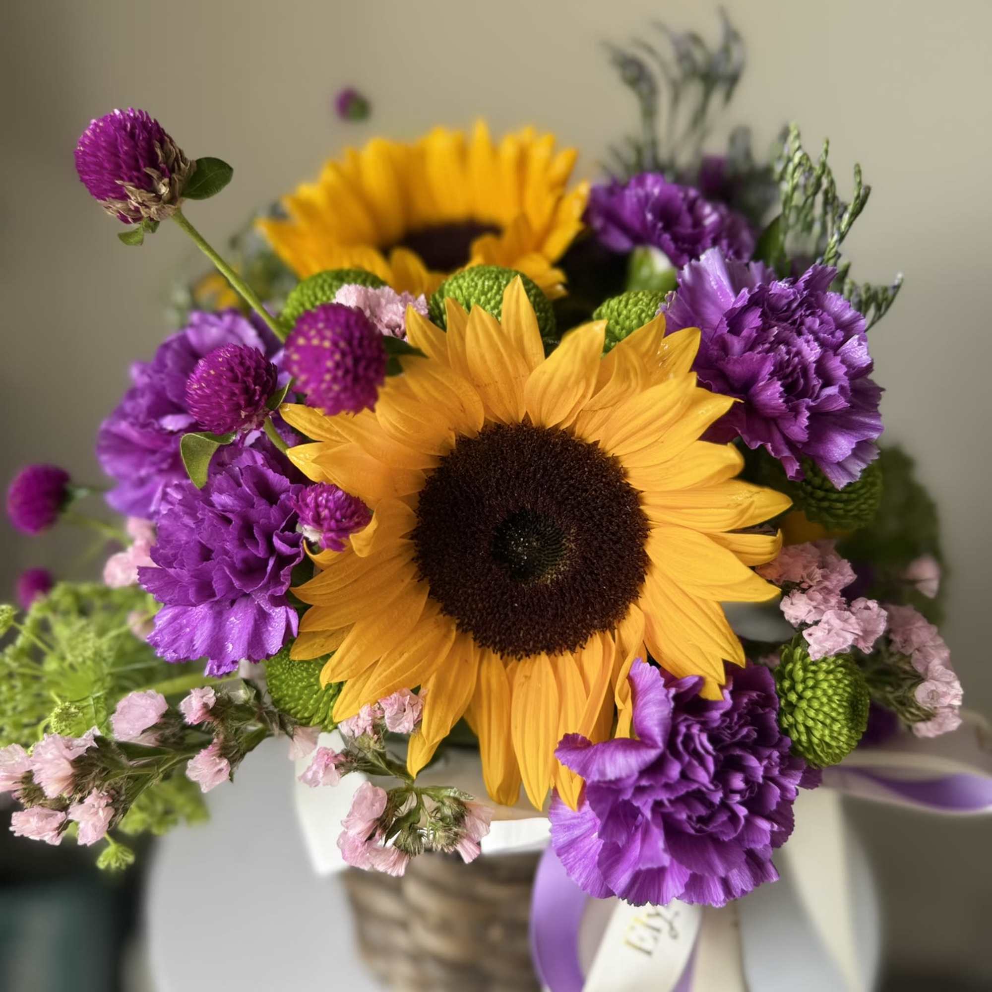 Discover the ideal floral gift with our vibrant basket arrangement, which features