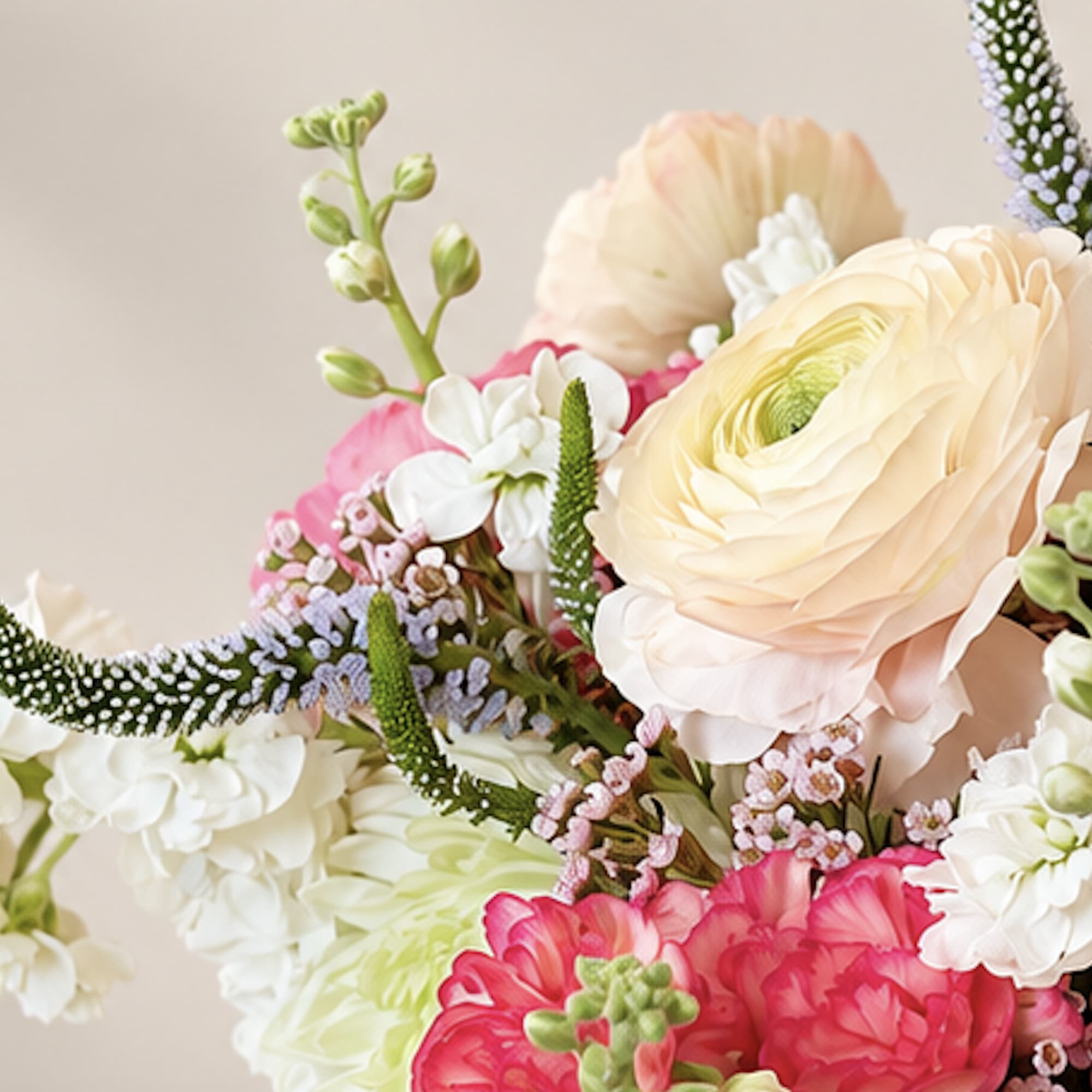 Bouquet of pale peach, pink, and white flowers with spiky accents