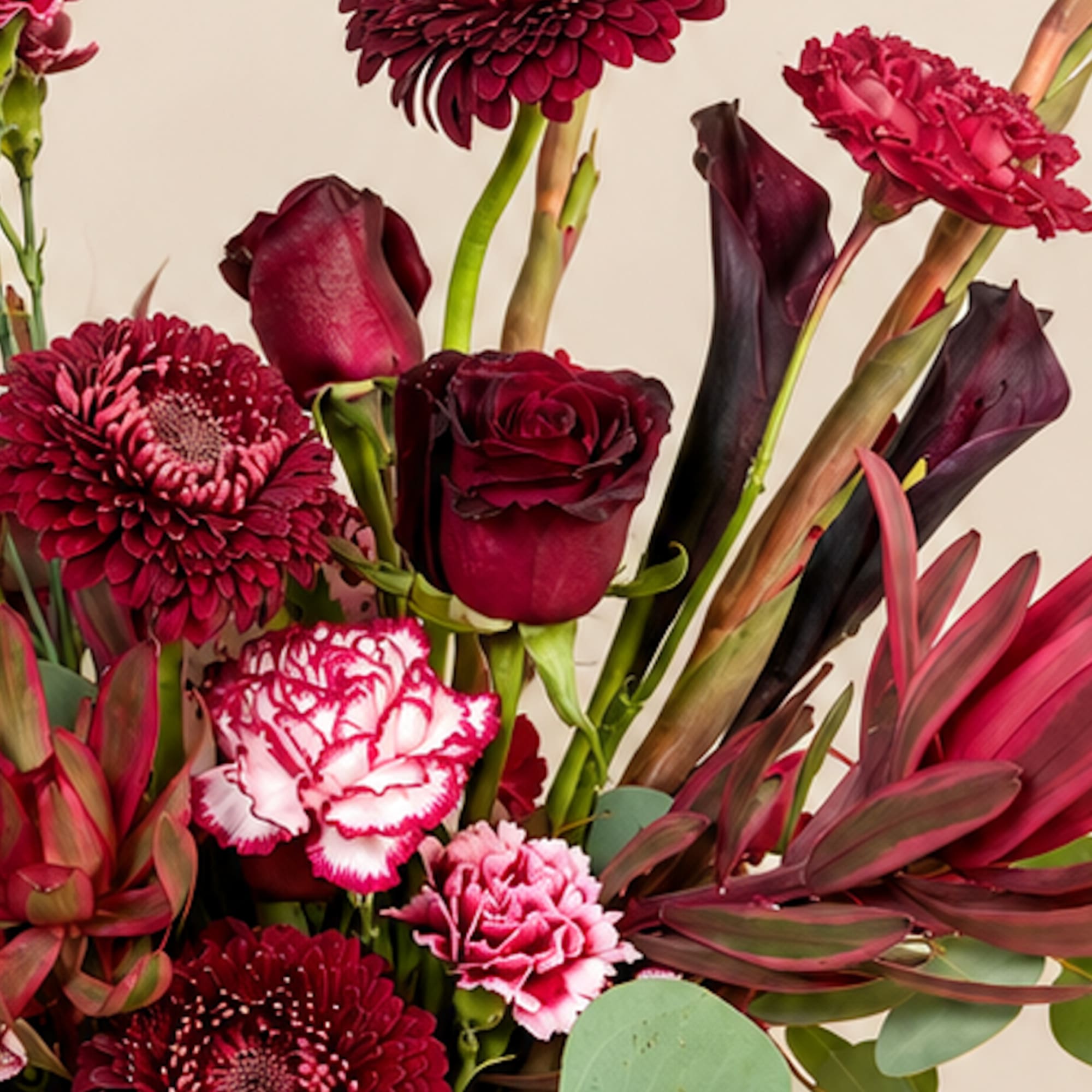 Deep red bouquet with roses, chrysanthemums, calla lilies, and carnations