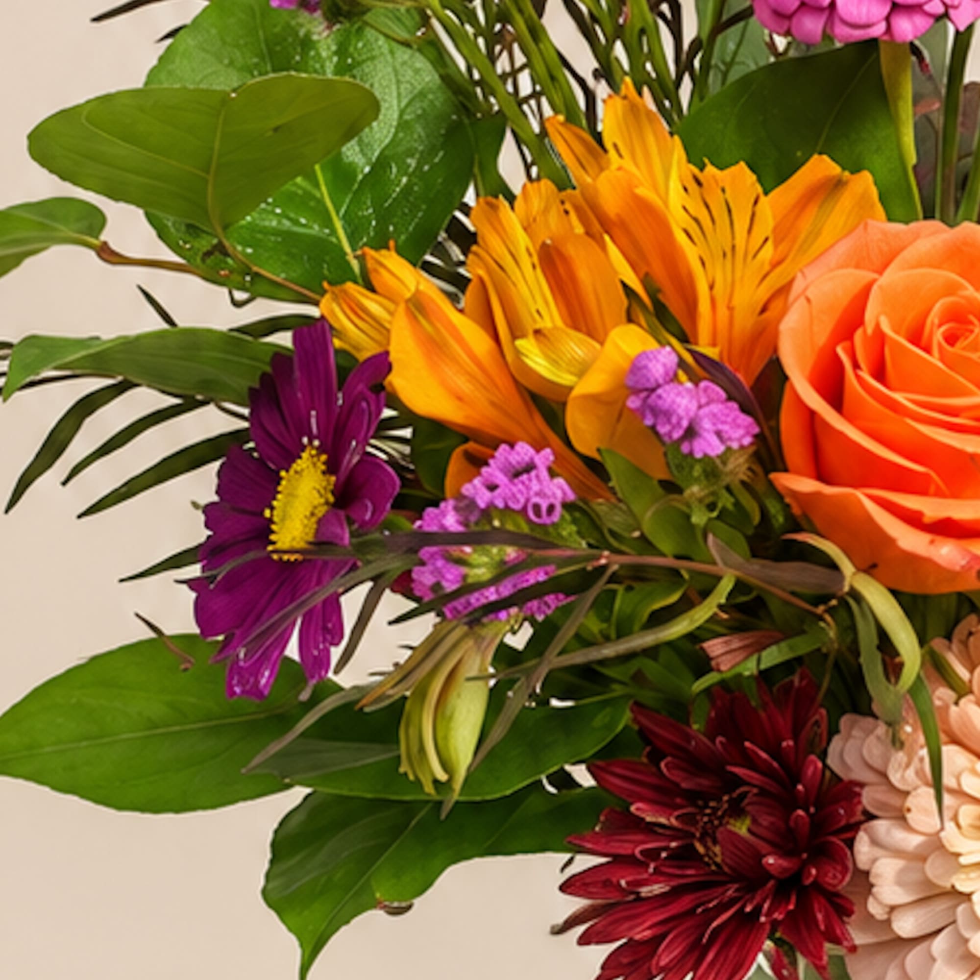 Colorful bouquet with orange roses and purple daisies