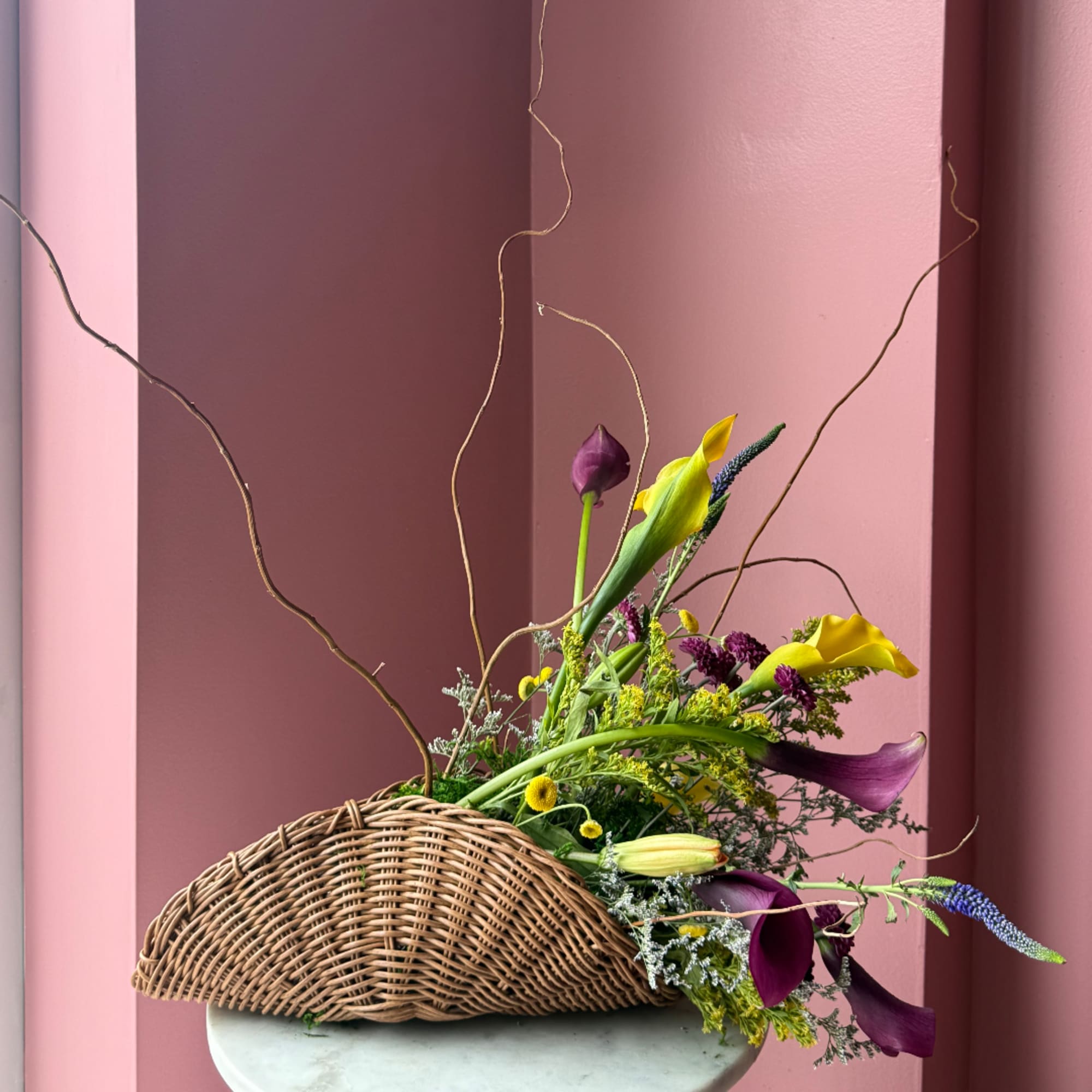 Basket arrangement with purple and yellow calla lilies