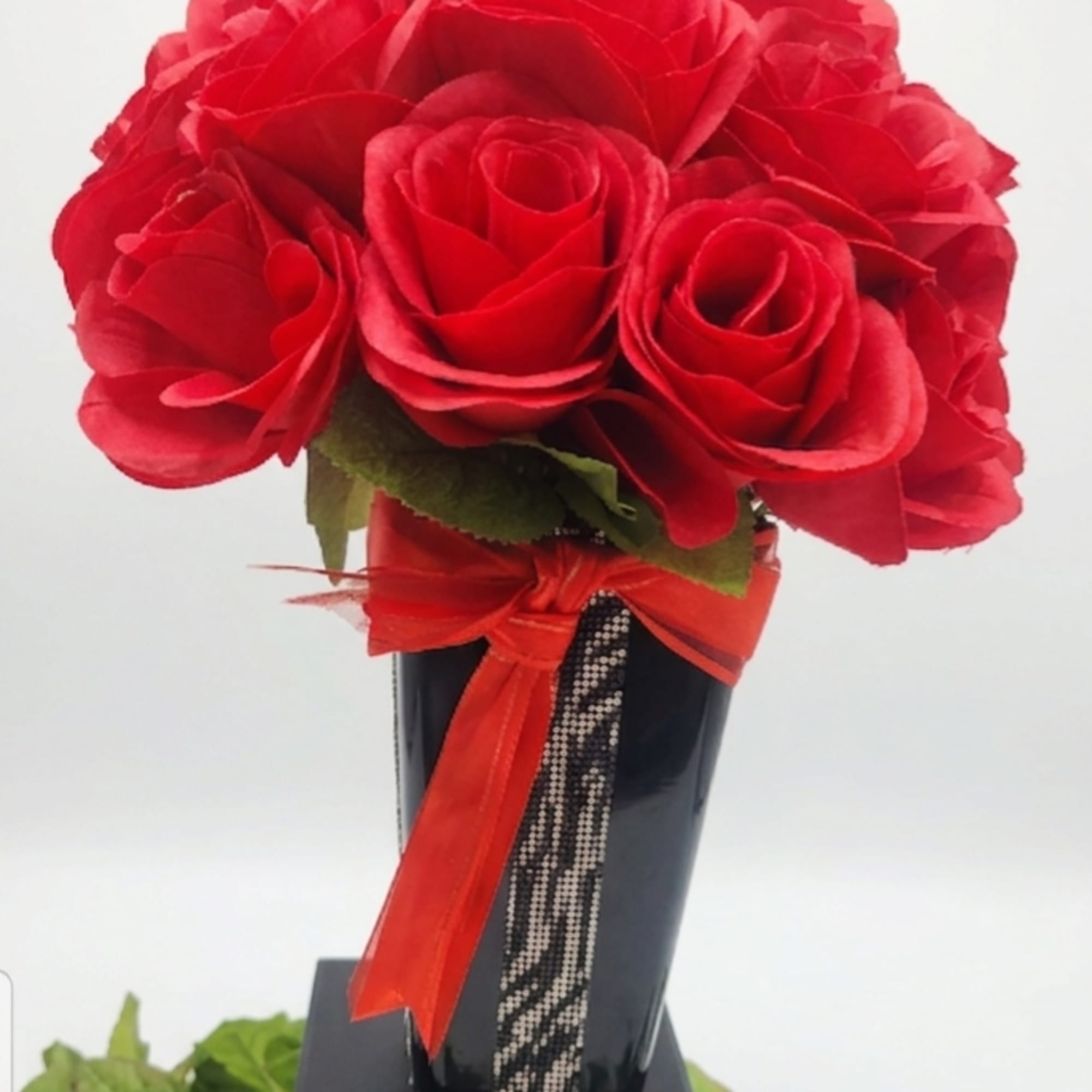 ​A striking, high-contrast arrangement designed to command attention. Vibrant, velvety red roses