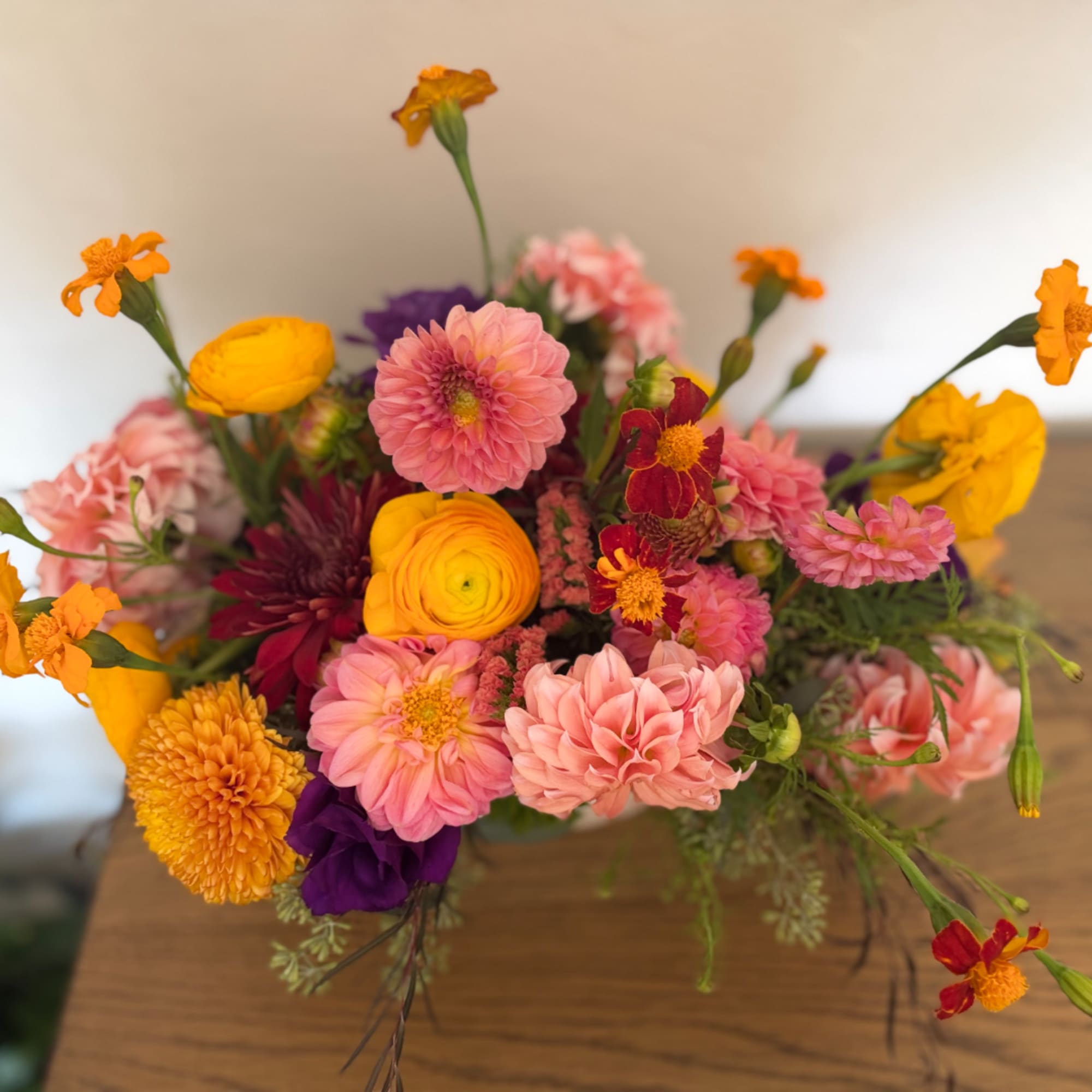 Colorful mixed bouquet with pink, yellow, orange, and purple flowers