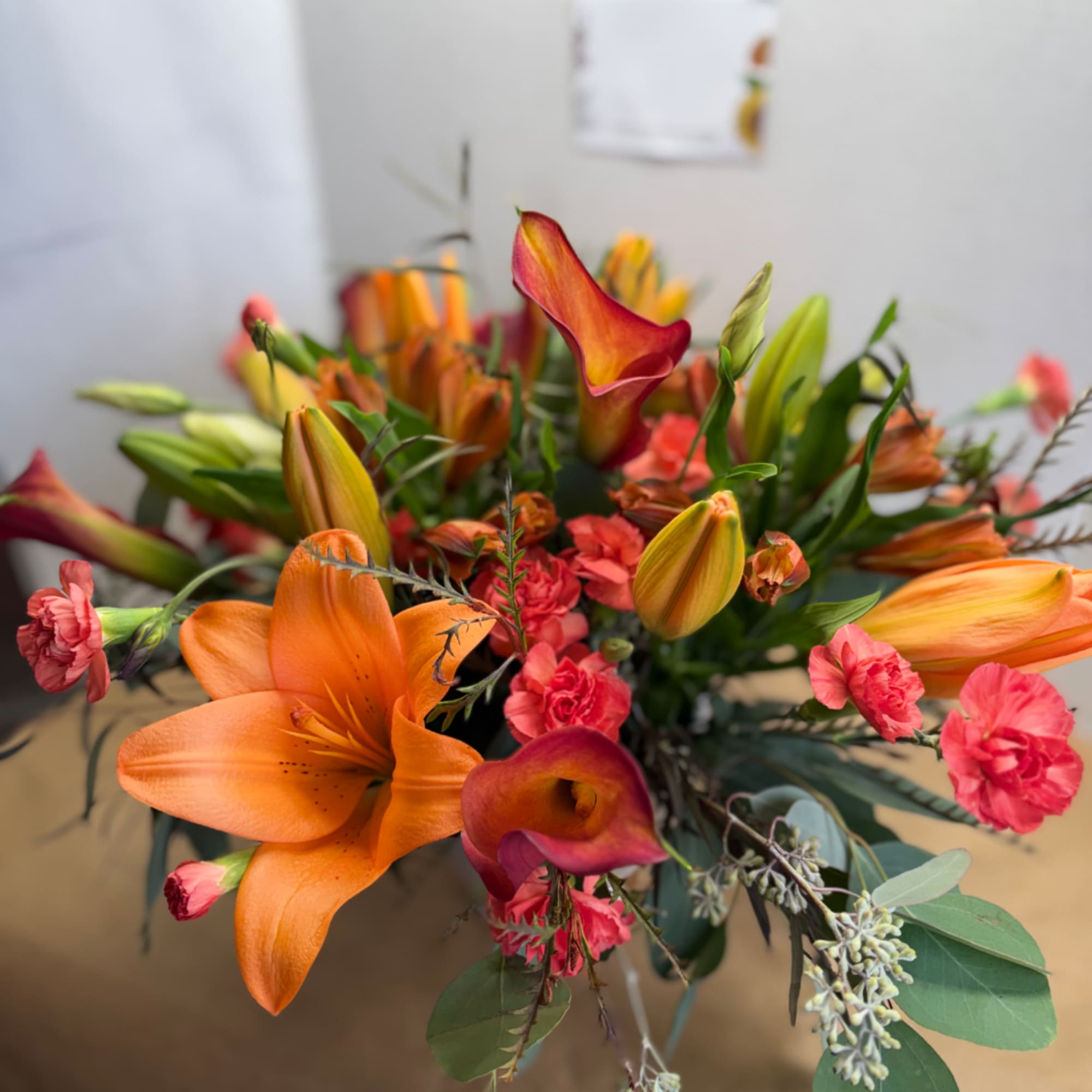 Orange lilies and pink calla lilies in a mixed bouquet